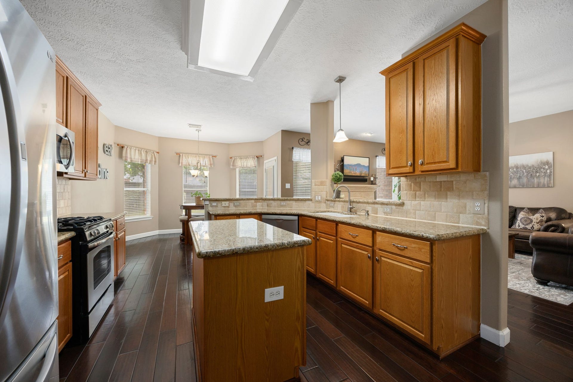 1427 Queens Bay Drive, Katy, TX 77494 The kitchen offers abundant custom cabinetry and generous counter space, plus a breakfast bar that's perfect for casual dining or entertaining guests.