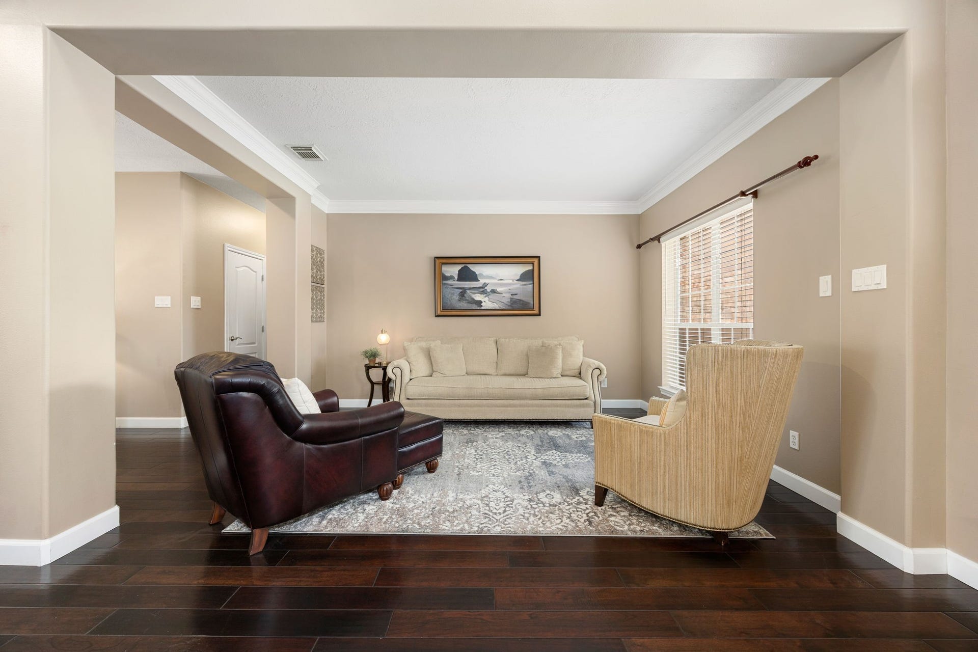 1427 Queens Bay Drive, Katy, TX 77494 A formal living area just off the foyer greets you with rich hardwood flooring, elegant crown molding, and large windows that fill the space with natural light.