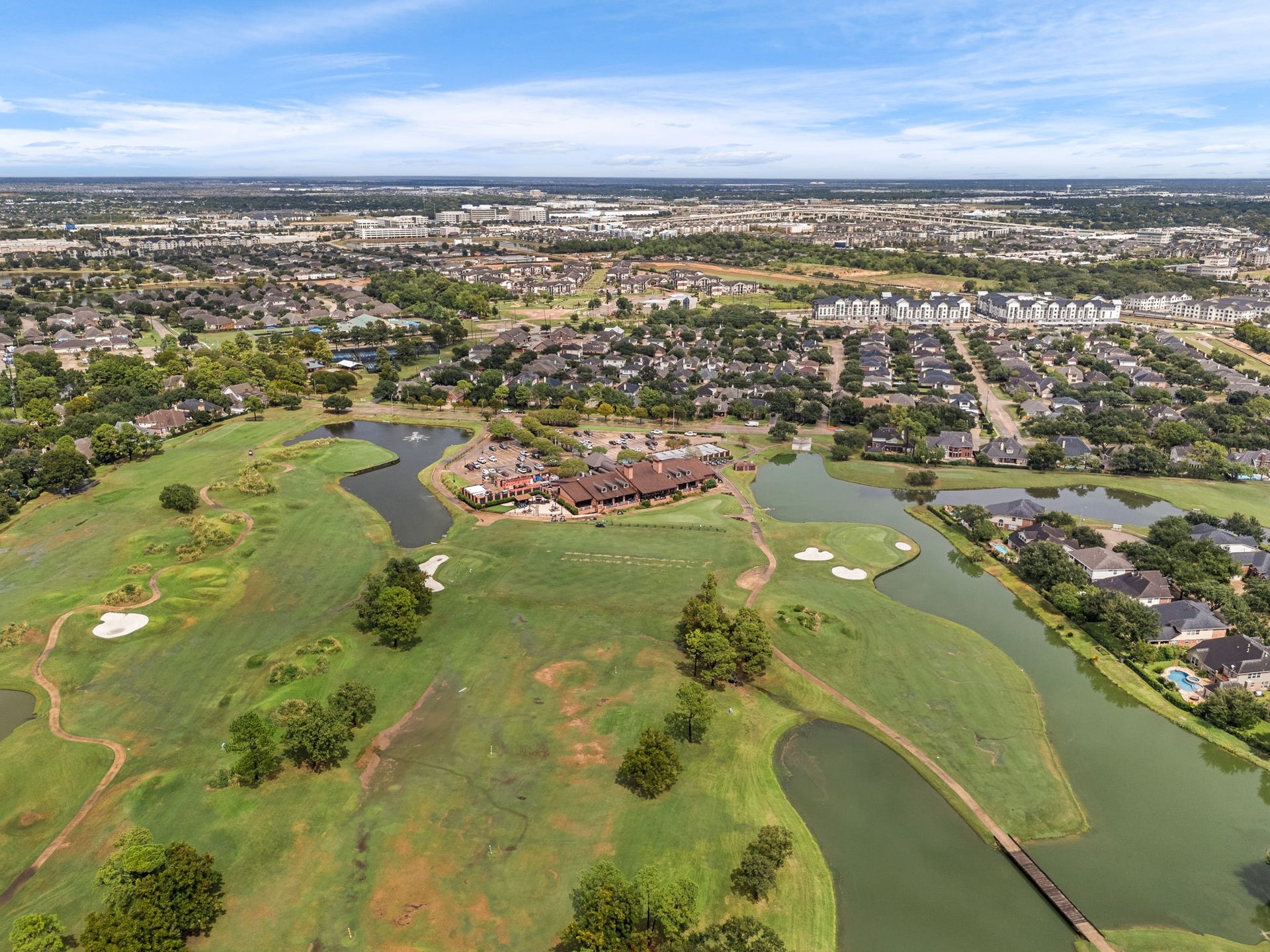 1427 Queens Bay Drive, Katy, TX 77494 An aerial view showcases the community's mature trees and proximity to the golf course and clubhouse.