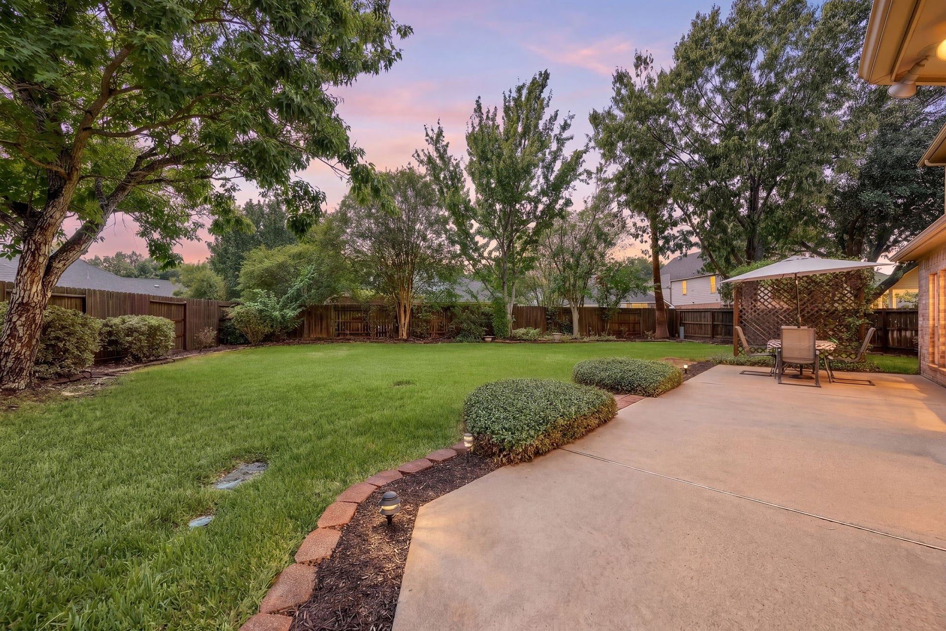1427 Queens Bay Drive, Katy, TX 77494 The backyard offers a spacious lawn and large patio space, perfect for relaxing evenings outdoors.