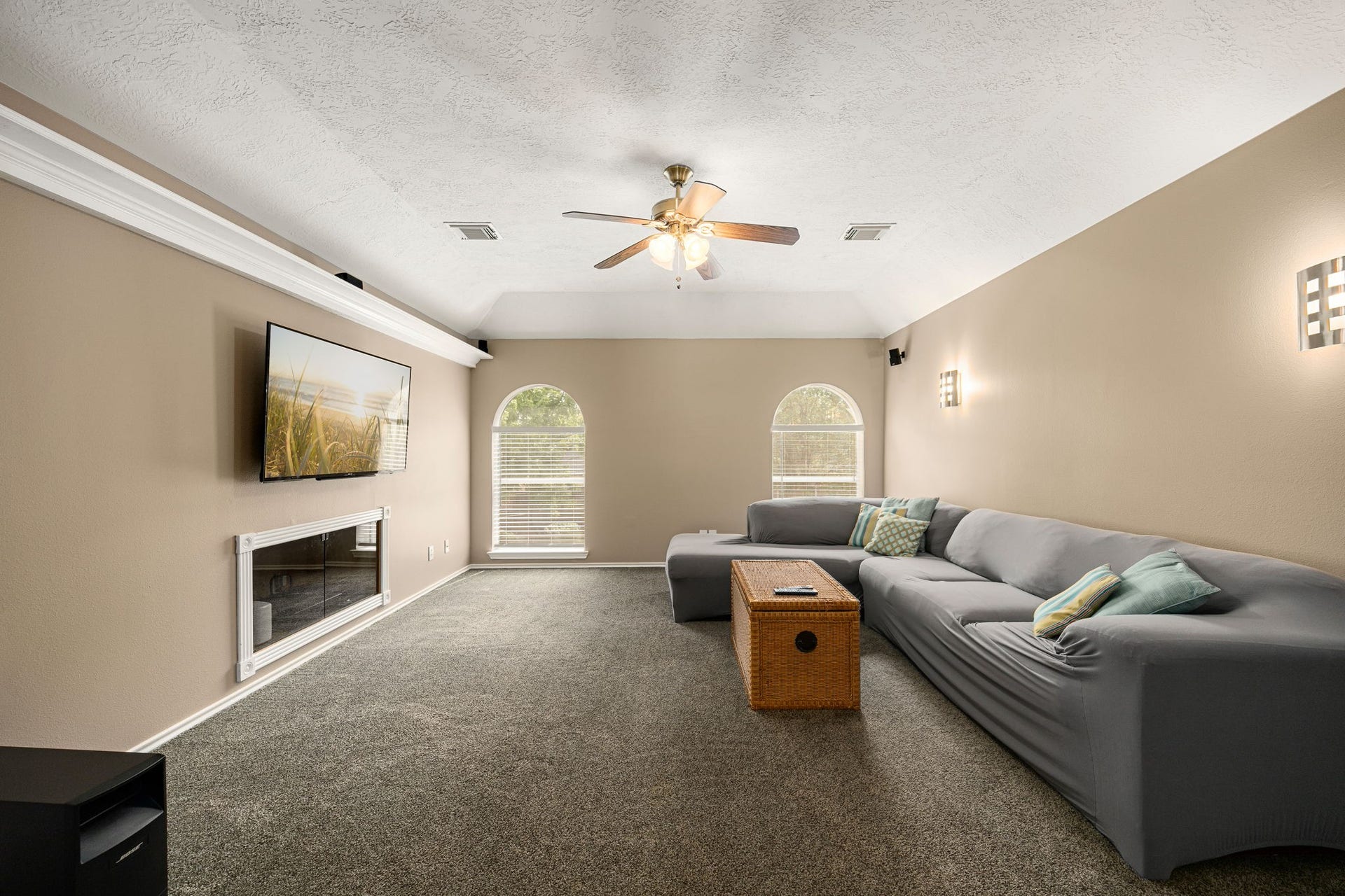 1427 Queens Bay Drive, Katy, TX 77494 The spacious game room/movie room offers vaulted ceilings and built-in surround sound the perfect setting for movie nights, game days, or entertaining guests.