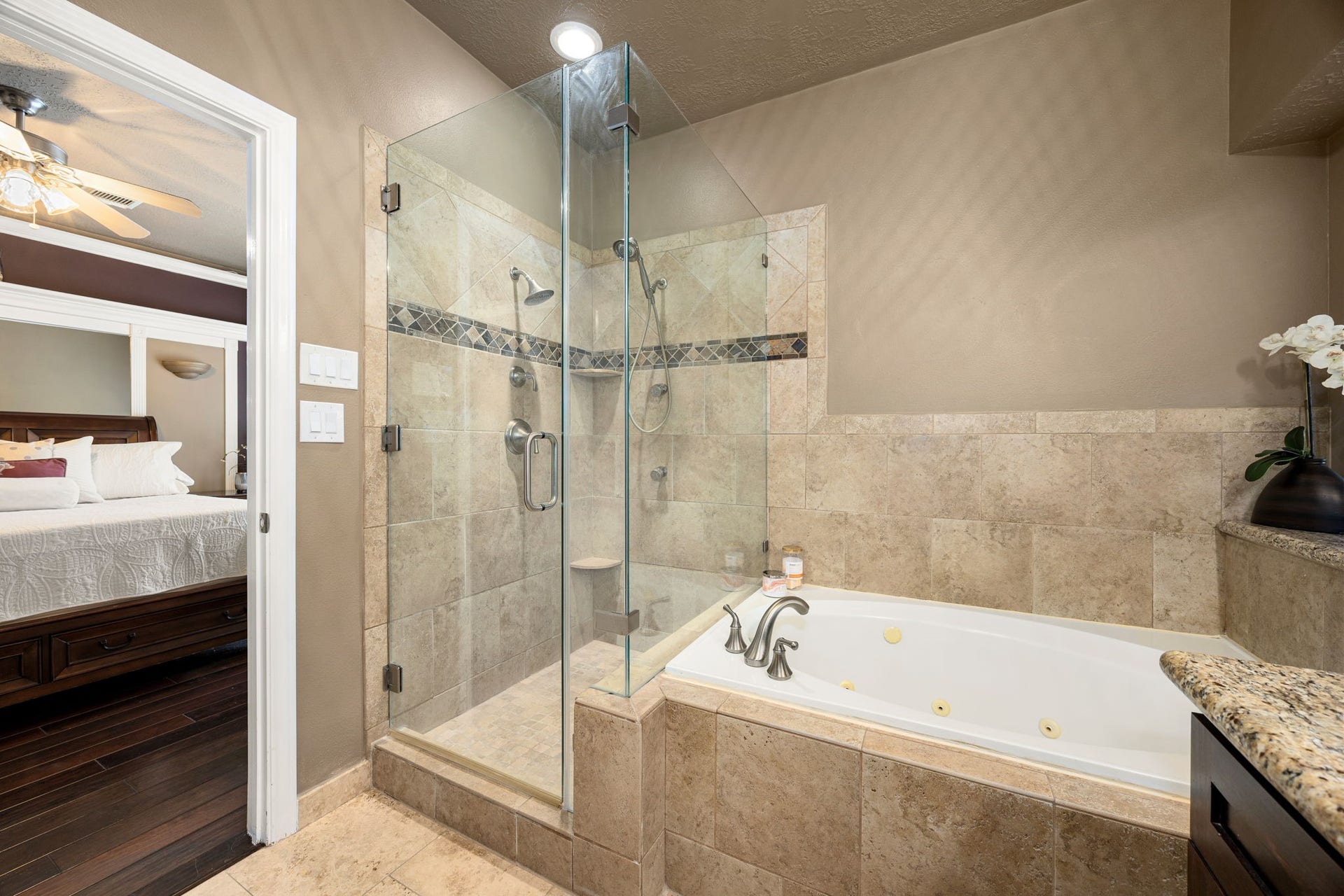 1427 Queens Bay Drive, Katy, TX 77494 A deep jetted soaking tub and a separate glass-enclosed shower with designer tile complete this ensuite retreat.