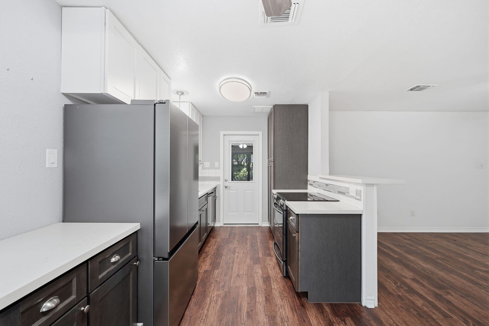 5208 Cunningham Drive, Pearland, TX 77581 View of Kitchen headed to Garage. Brand New Refrigerator included.
