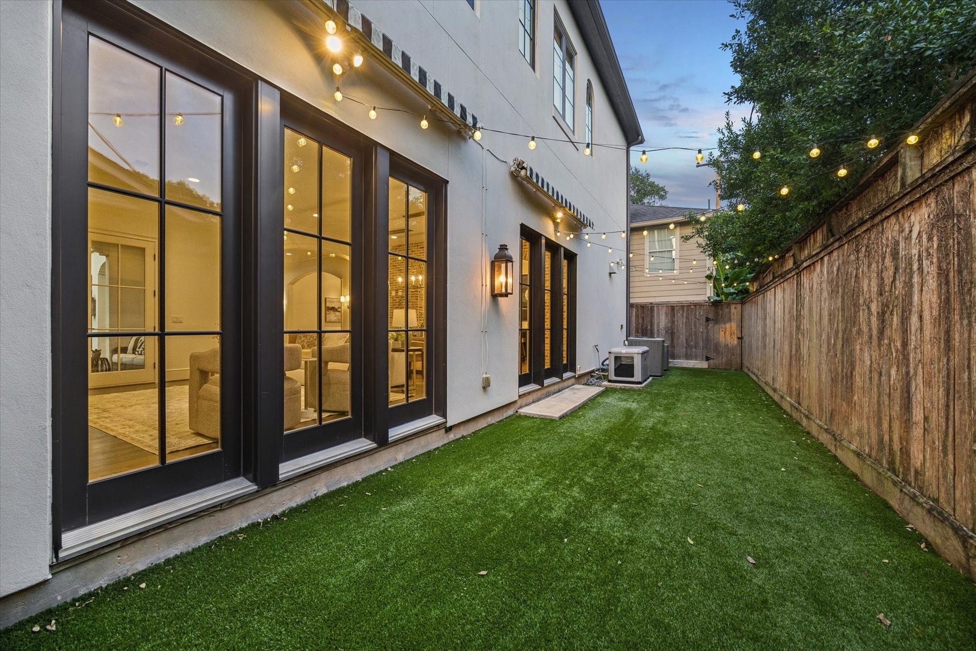 1647 Vassar Street, Houston, TX 77006 Beautifully designed backyard with elegant French doors creating seamless indoor-outdoor living.