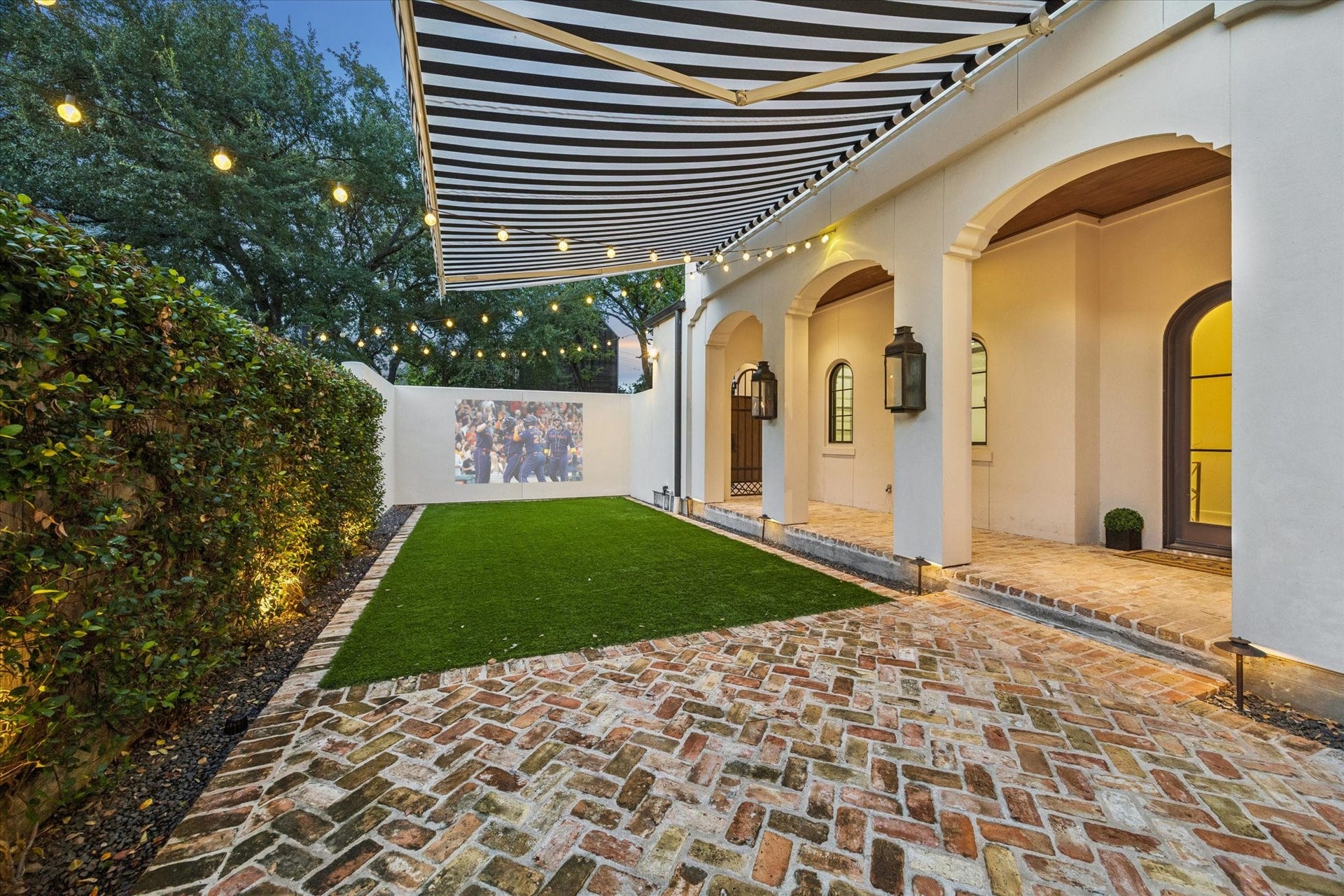 1647 Vassar Street, Houston, TX 77006 Expansive courtyard with brick pavers and shaded seating for effortless outdoor entertaining.