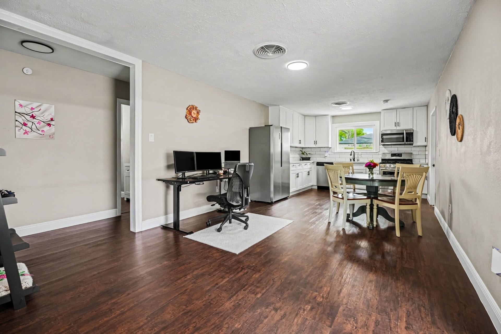 1317 N Natchez Drive, Texas City, TX 77591 Spacious open-plan kitchen and dining area with laminate floors, modern stainless steel appliances, and ample natural light.