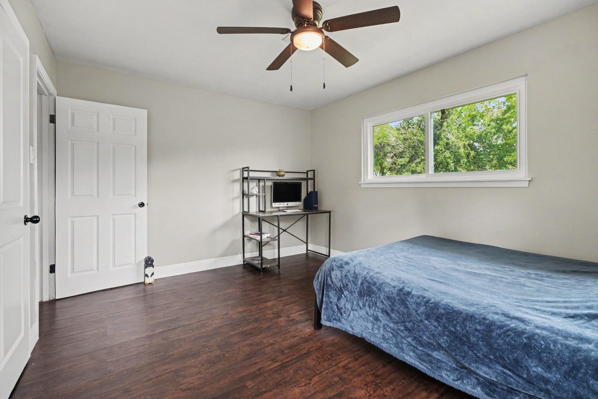 1317 N Natchez Drive, Texas City, TX 77591 Bedroom One a large window providing natural light, and a ceiling fan for comfort.