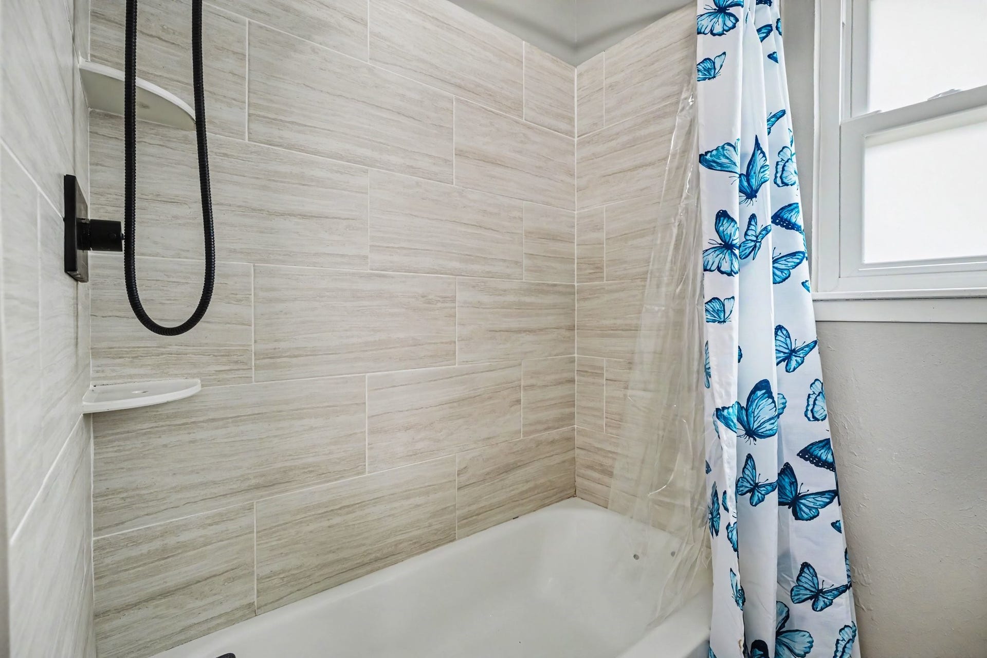 1317 N Natchez Drive, Texas City, TX 77591 Shared Modern bathroom with elegant tilework offering a fresh and inviting space.