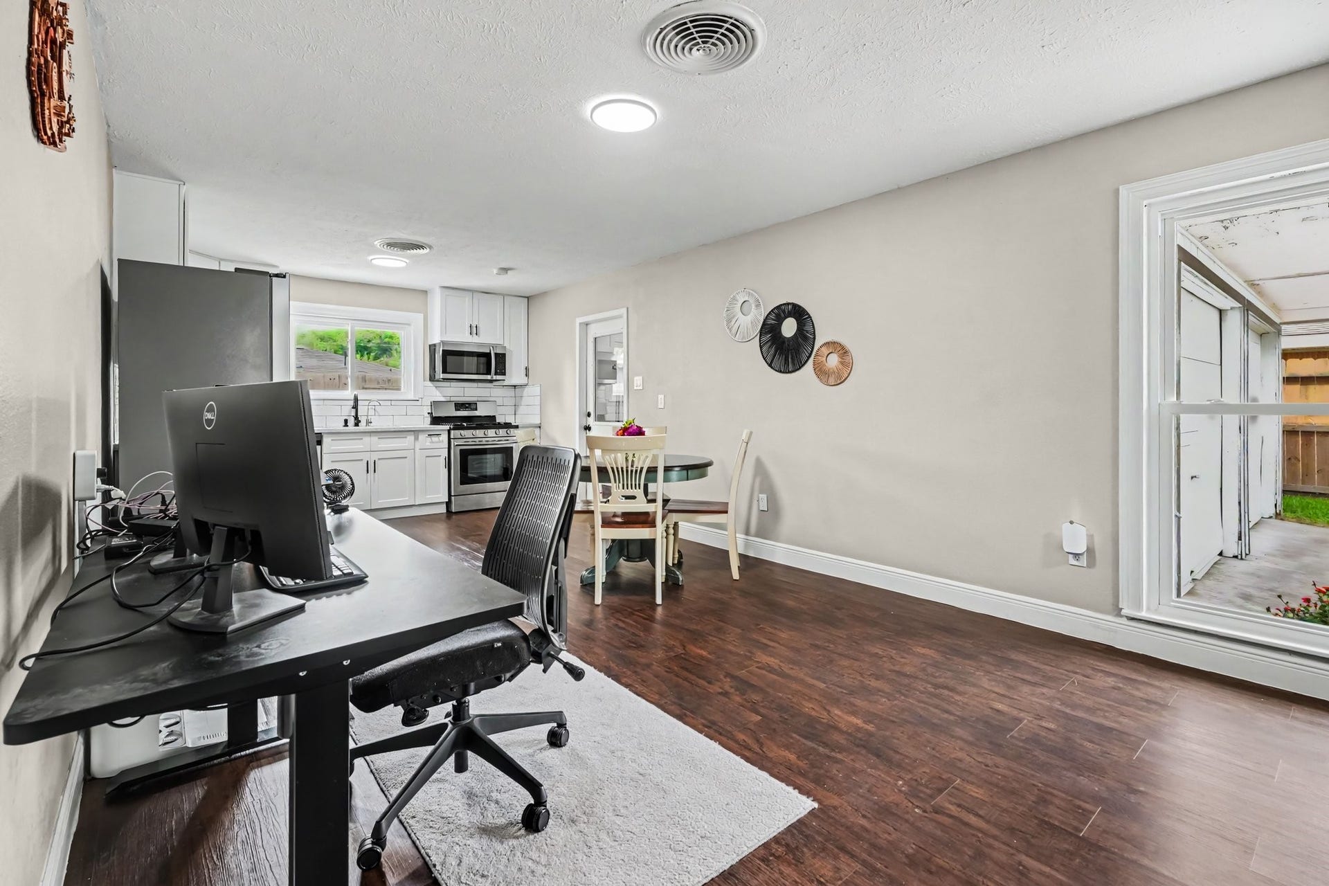 1317 N Natchez Drive, Texas City, TX 77591 Bright and open kitchen with modern appliances and ample counter space, seamlessly connected to a cozy dining area and adjacent home office nook.