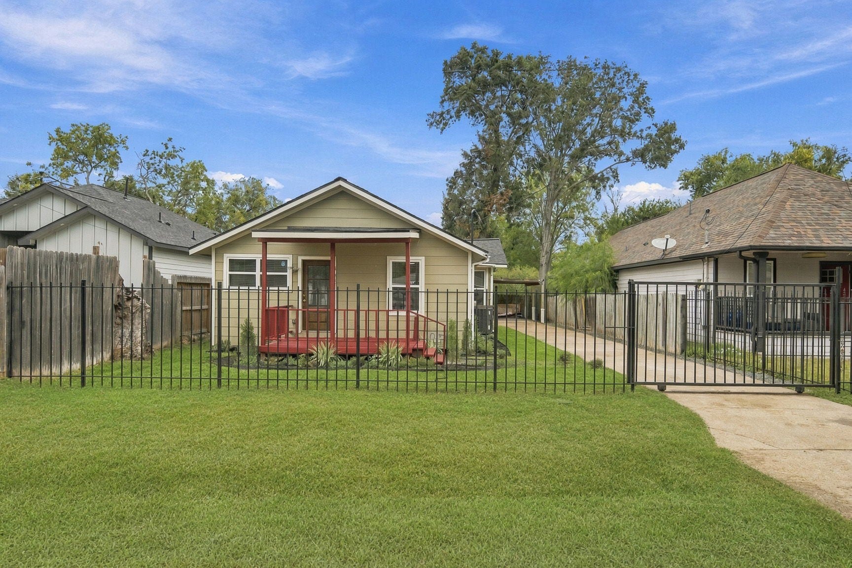 4637 Larkspur Street, Houston, TX 77051 Charming single-story home with a welcoming front porch, neatly fenced yard, and a long driveway leading to ample parking.
