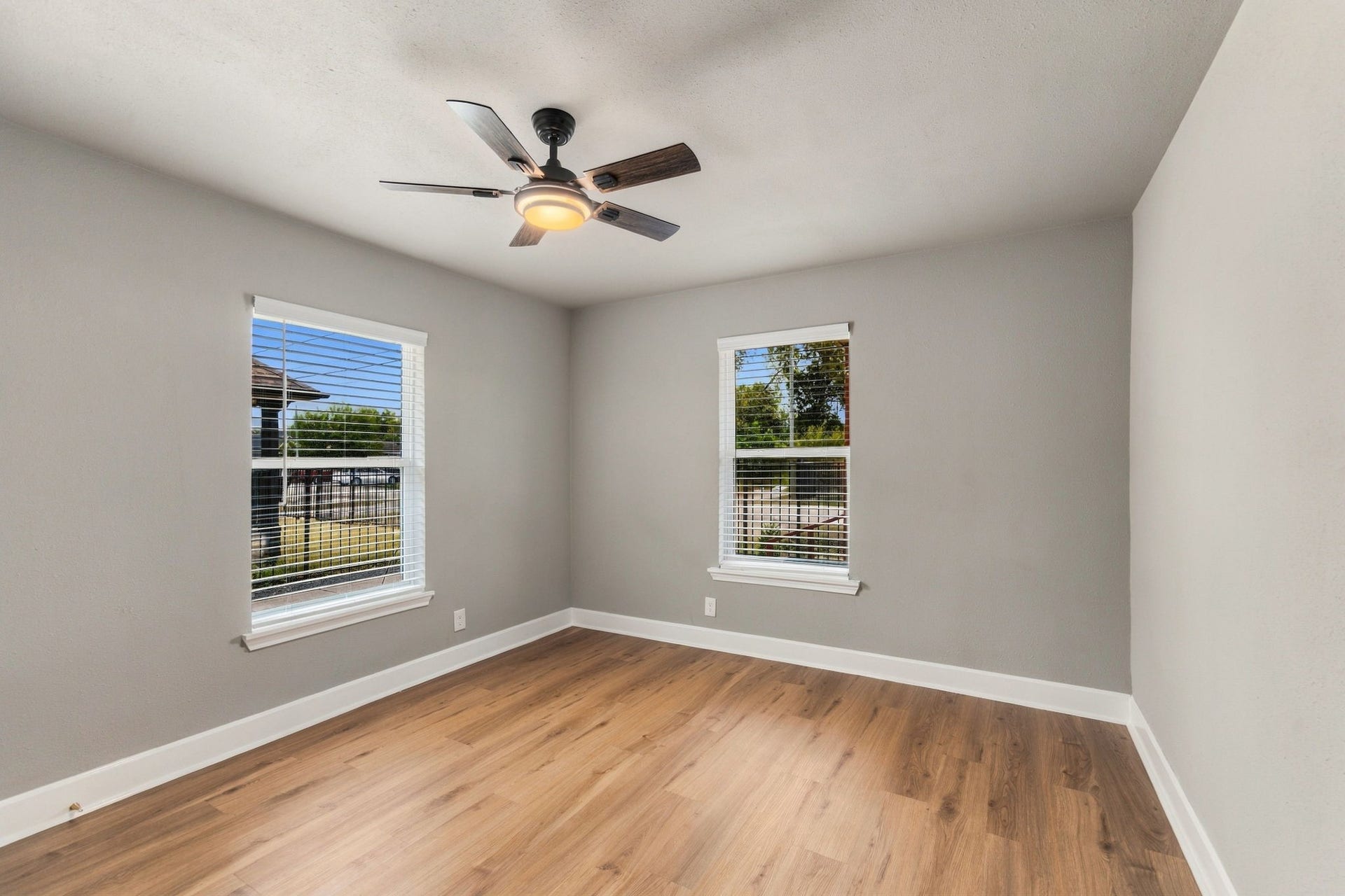 4637 Larkspur Street, Houston, TX 77051 Bright and inviting room with large windows, modern ceiling fan, and beautiful hardwood floors.