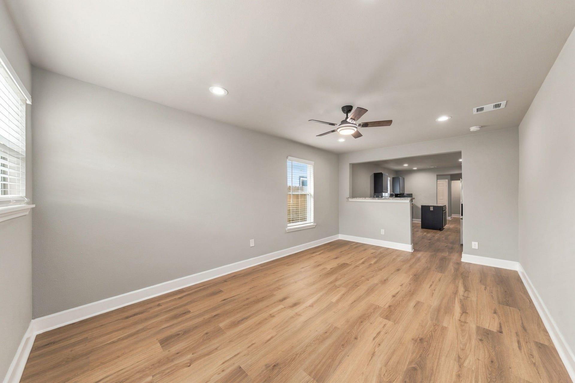 4637 Larkspur Street, Houston, TX 77051 Bright and spacious living area with hardwood floors, modern ceiling fan, and recessed lighting, seamlessly connected to the kitchen for easy entertaining.