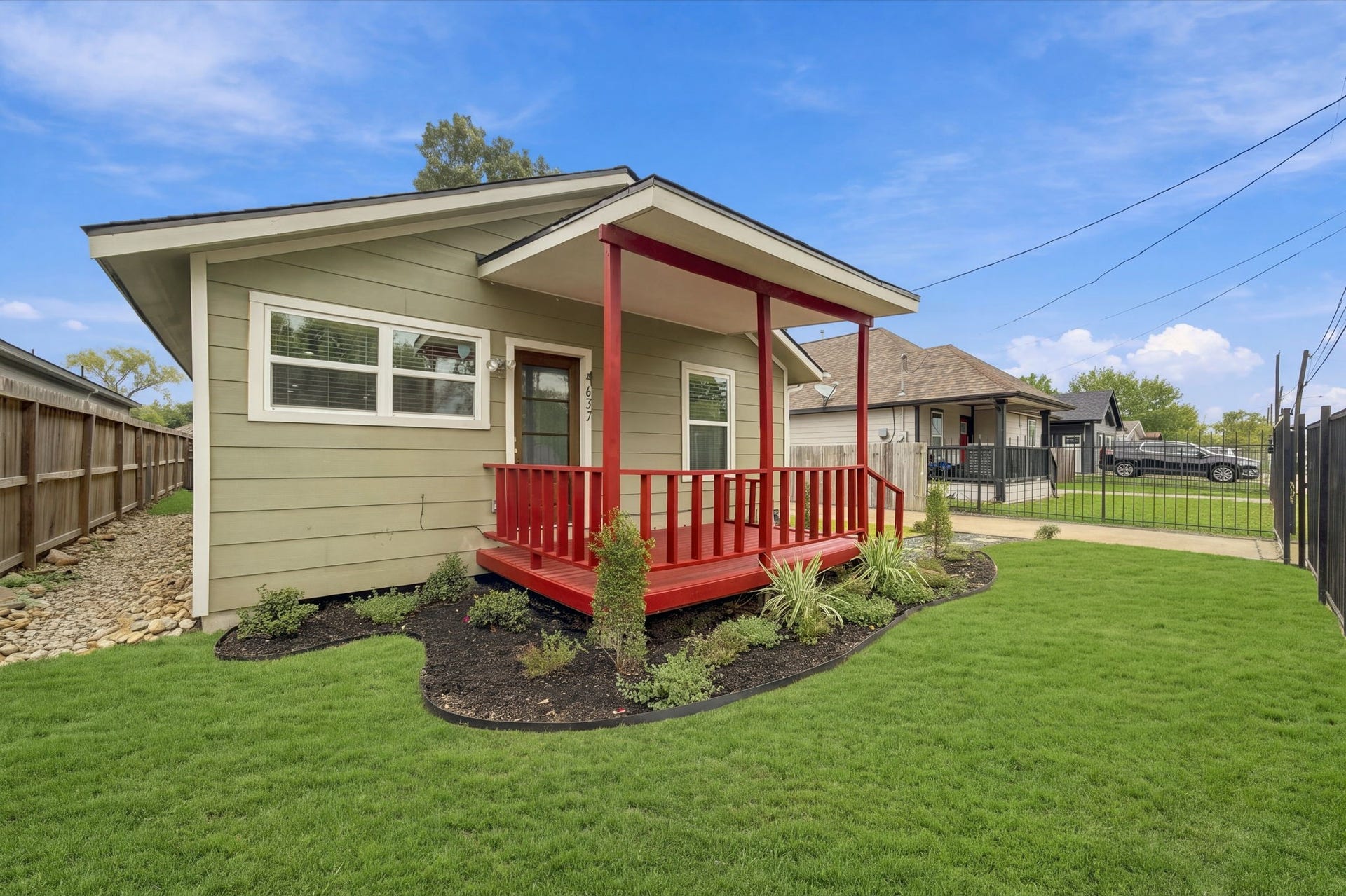 4637 Larkspur Street, Houston, TX 77051 Charming bungalow with a welcoming front porch, vibrant landscaping, and a lush green lawn, perfect for enjoying outdoor relaxation.