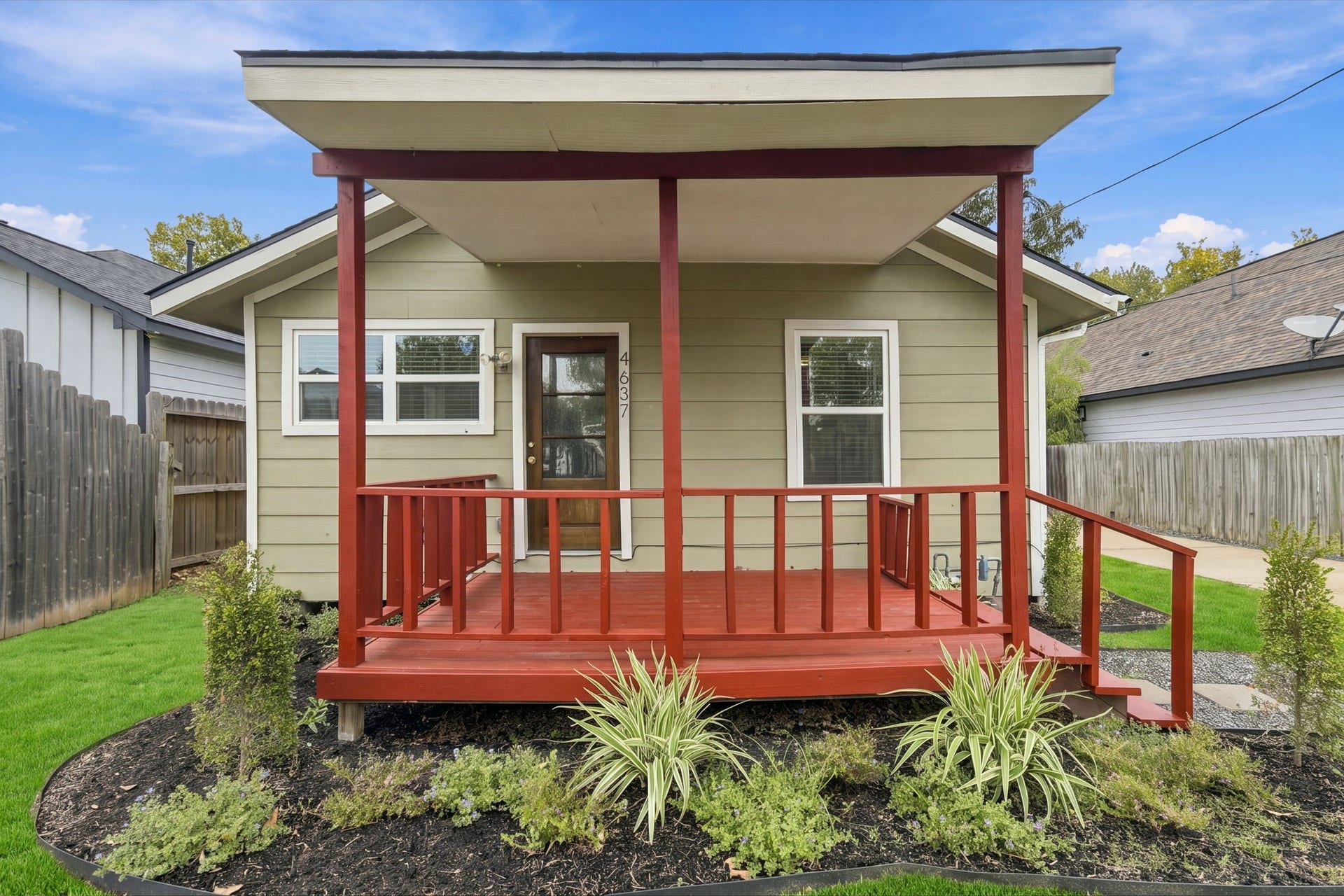 4637 Larkspur Street, Houston, TX 77051 Charming single-story home with a welcoming red front porch, set amidst well-maintained landscaping.