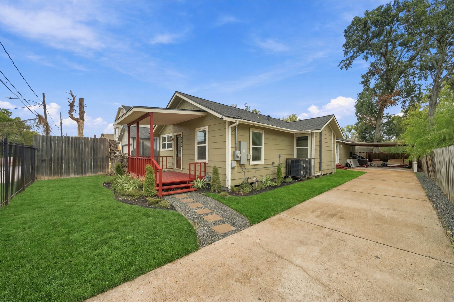 4637 Larkspur Street, Houston, TX 77051 Charming single-story home with a welcoming red front porch, manicured lawn, and long driveway leading to a covered parking area.