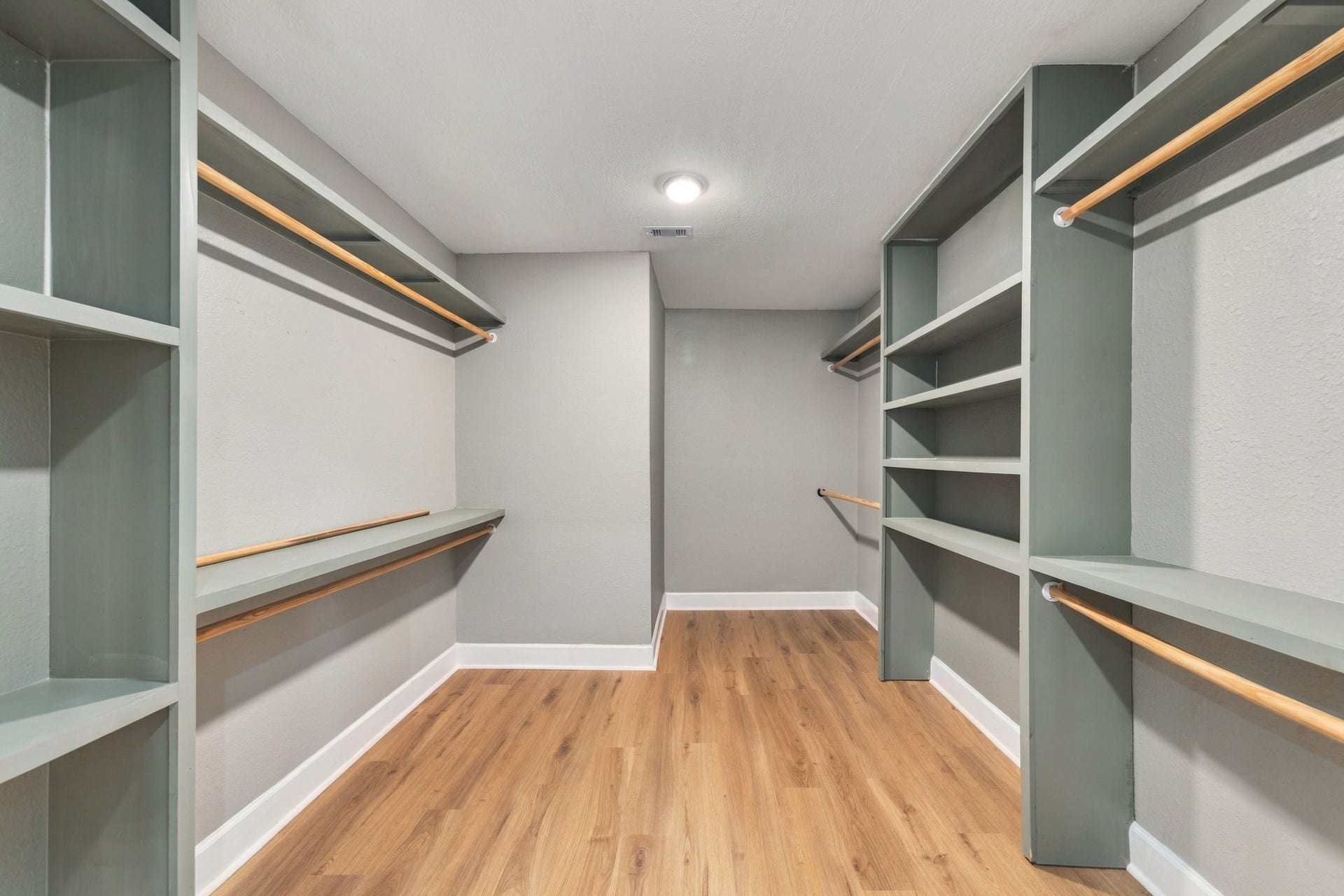 4637 Larkspur Street, Houston, TX 77051 Spacious walk-in closet featuring ample shelving and hanging space, complemented by elegant wood flooring.