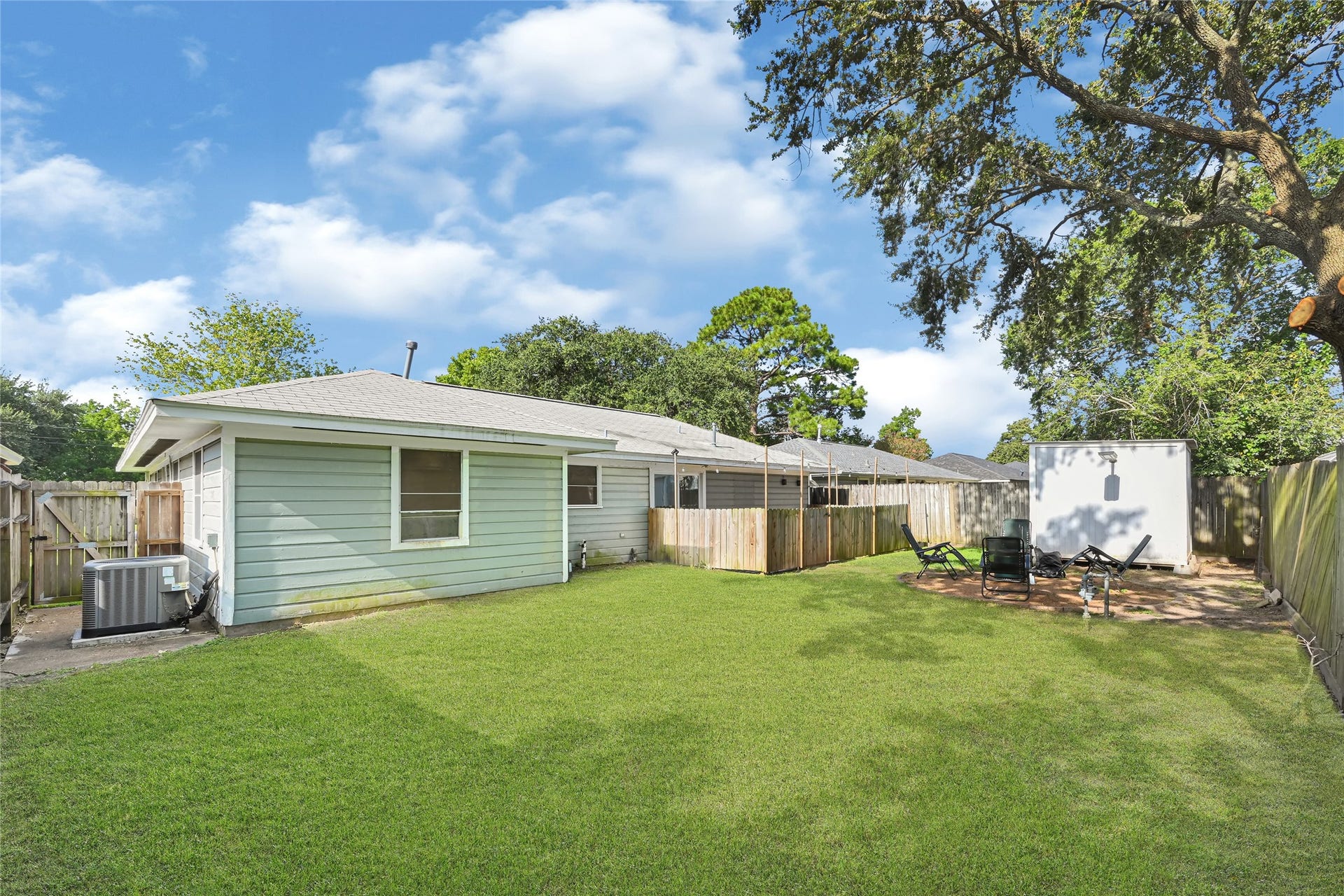 209 W 6th Street, Deer Park, TX 77536 The back lawn is perfect for hosting summer barbecues, creating a play area, or enjoying peaceful afternoons, offering endless landscaping and gardening possibilities.