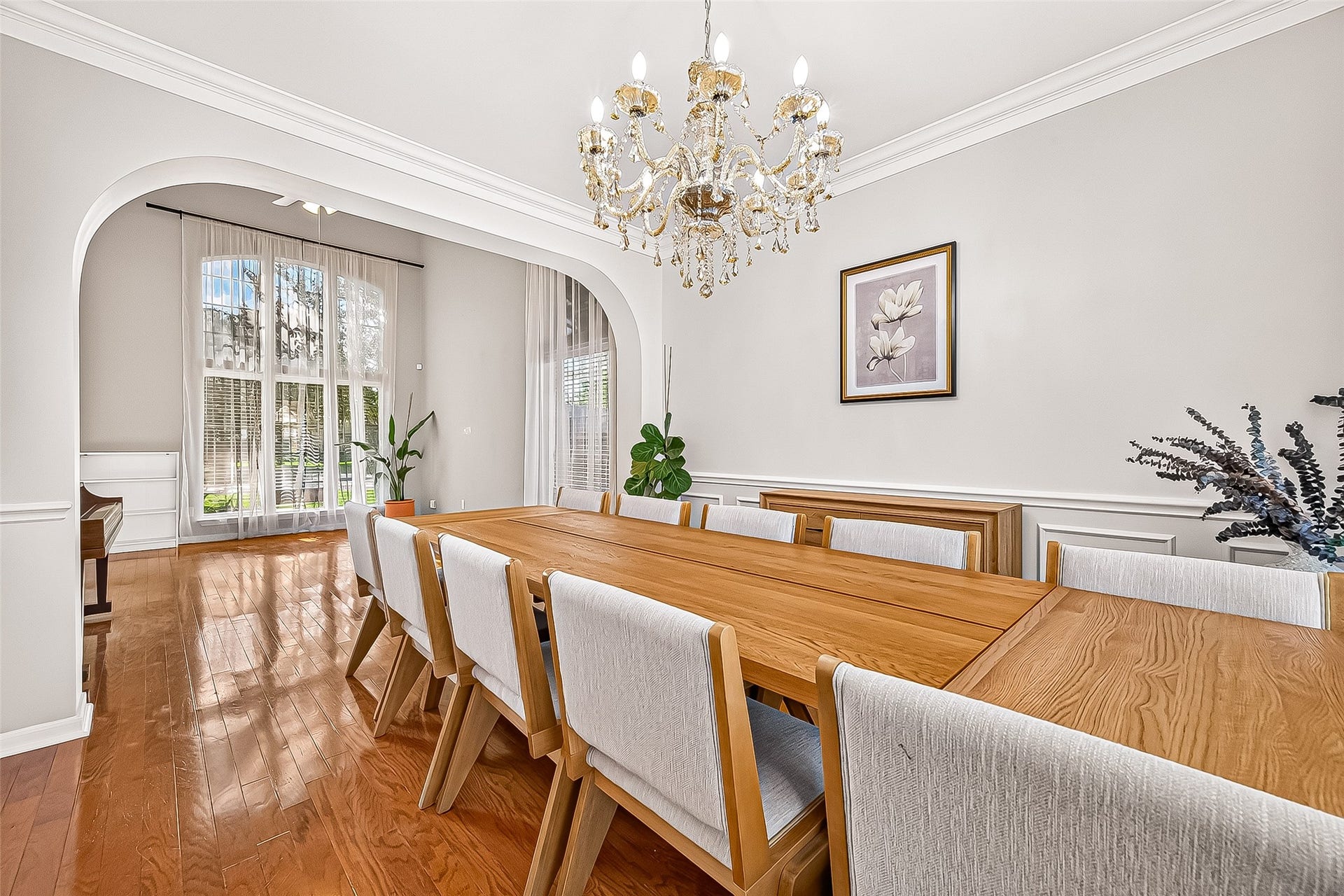 7406 Pleasant Ridge Drive, Houston, TX 77095 the formal dining room, highlighting the elegant arched doorway and natural lighting