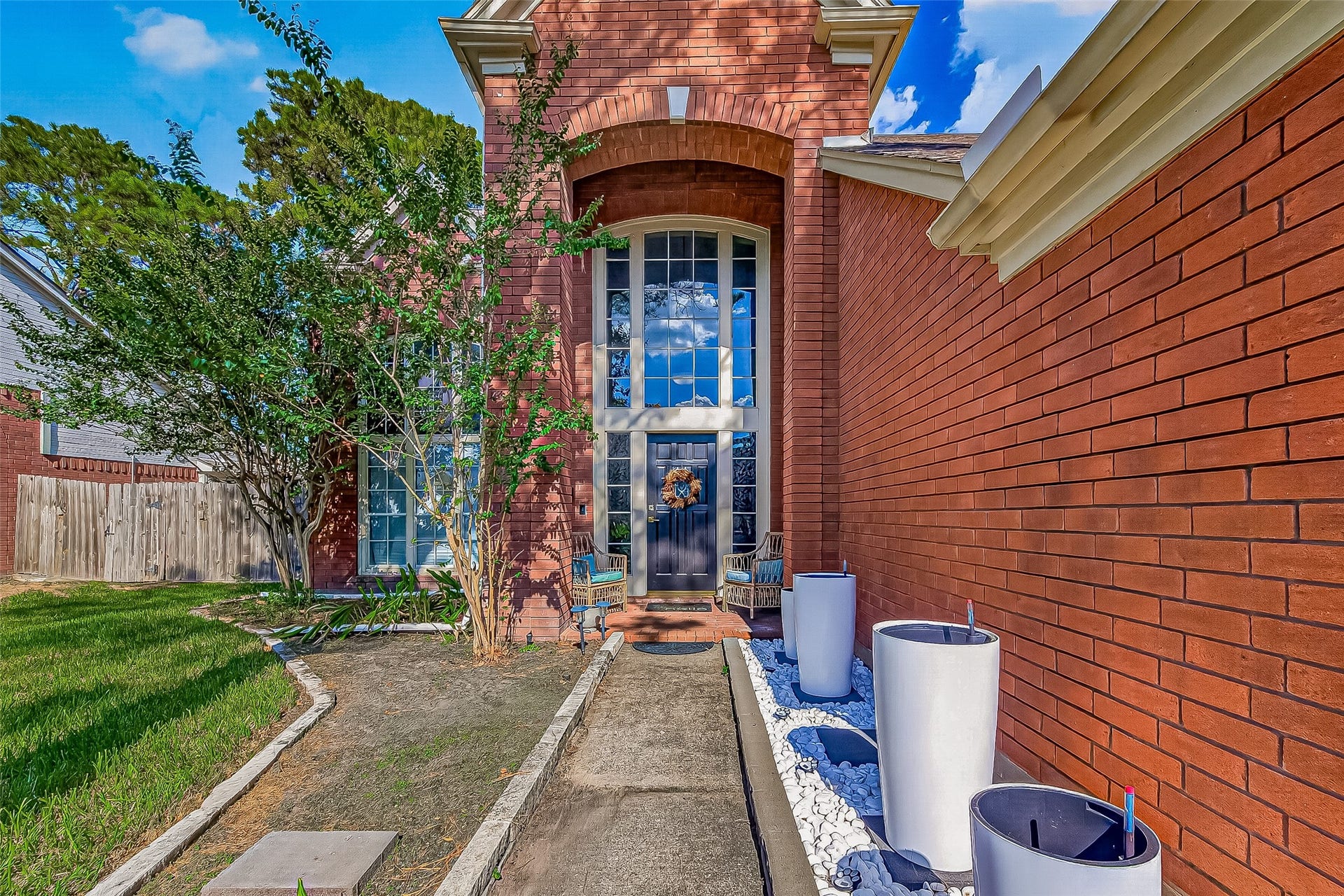 7406 Pleasant Ridge Drive, Houston, TX 77095 front exterior featuring floor-to-ceiling glass windows and manicured landscaping