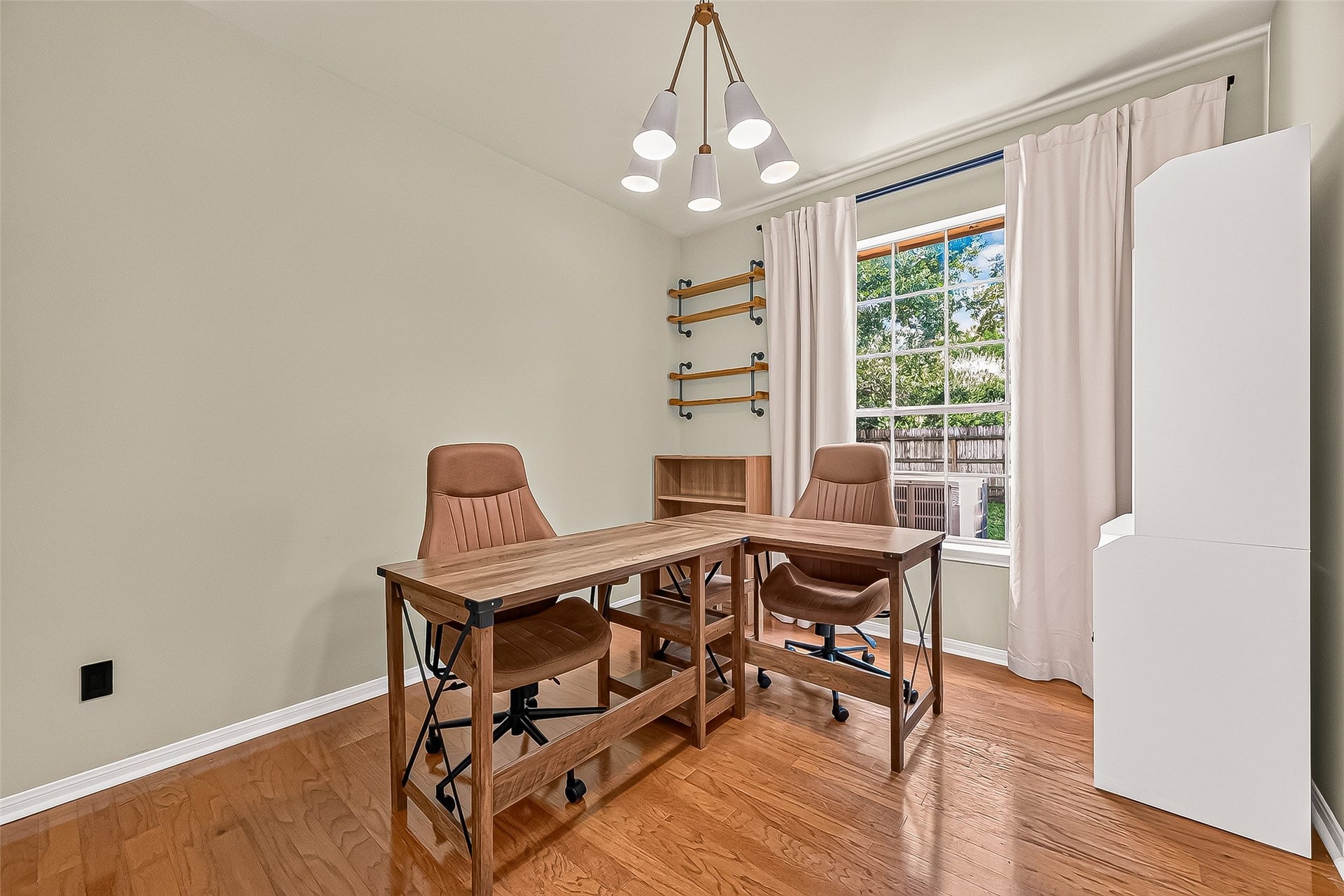 7406 Pleasant Ridge Drive, Houston, TX 77095 Downstairs bedroom currently staged as a sun-drenched home office/study
