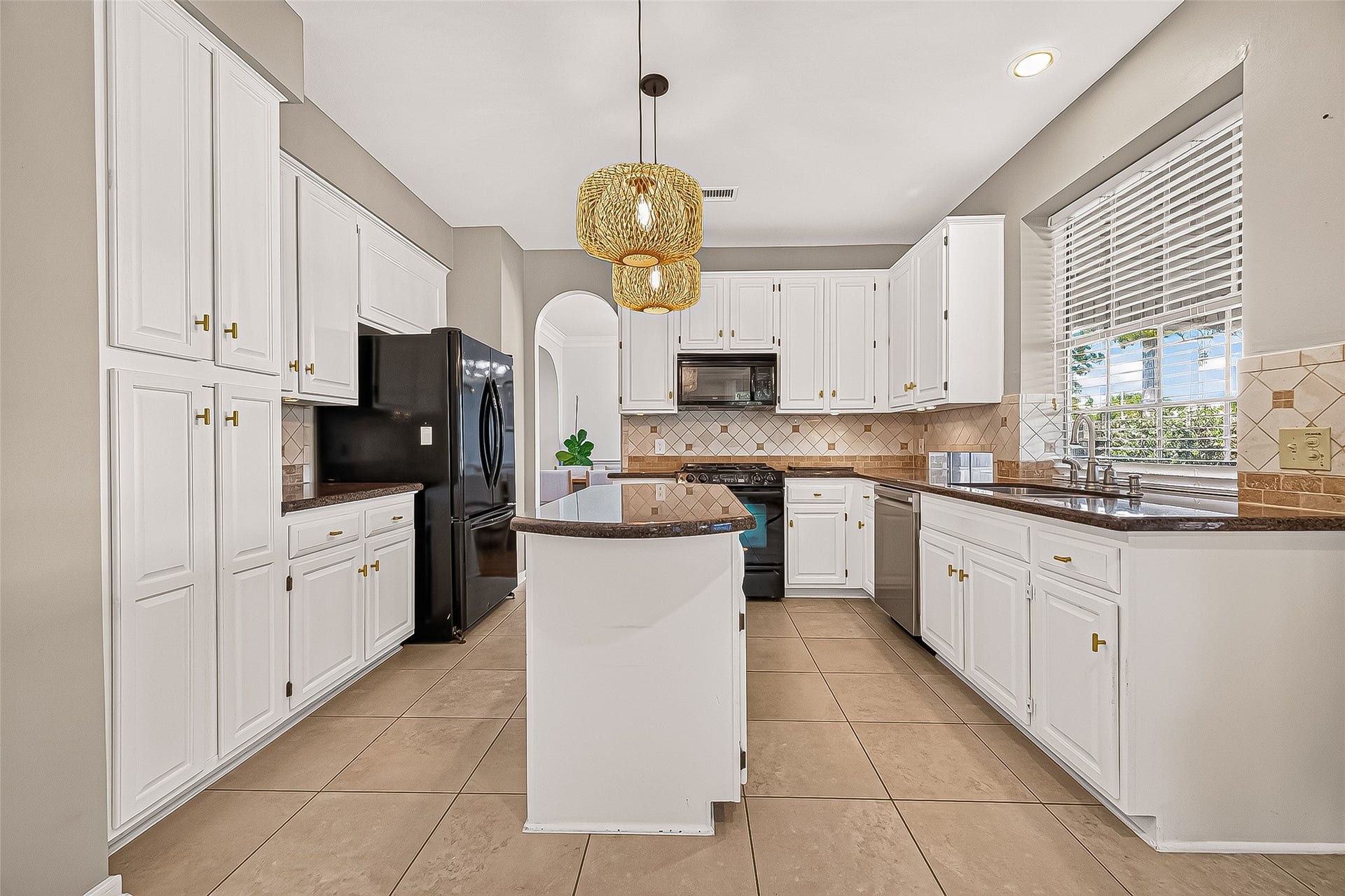 7406 Pleasant Ridge Drive, Houston, TX 77095 kitchen features ample storage space, elegant granite countertops, and a convenient center island