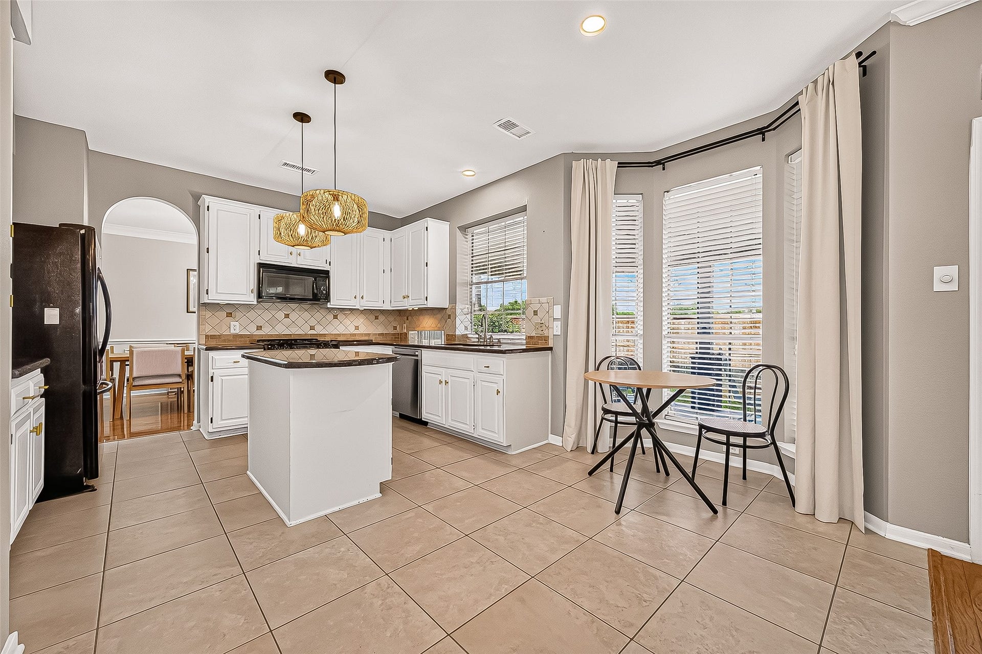 7406 Pleasant Ridge Drive, Houston, TX 77095 Bright and airy kitchen featuring an open-concept layout that flows seamlessly into the spacious family room,
