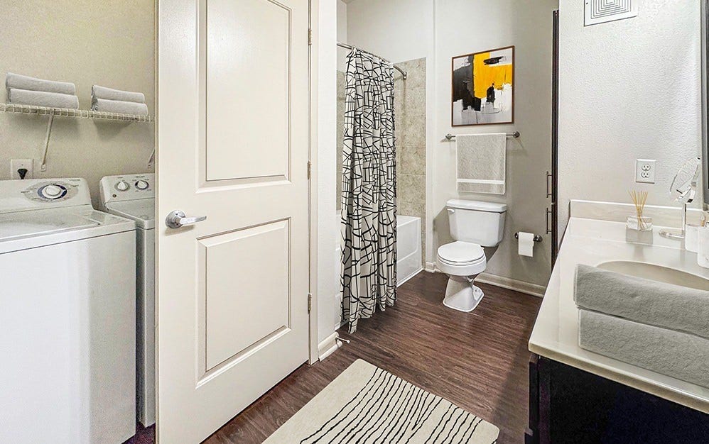 Side by side washer and dryer in unit.