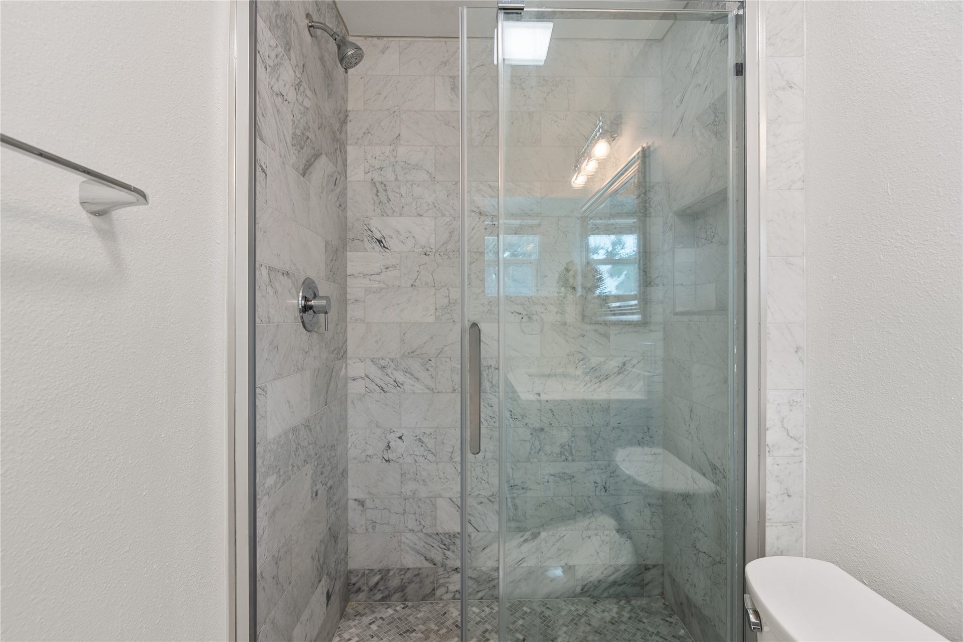 2302 Willowby Drive, Houston, TX 77008 Another view of the walk-in shower with beautiful marble style tile with modern fixtures, stainless shower door, and tiled niche.