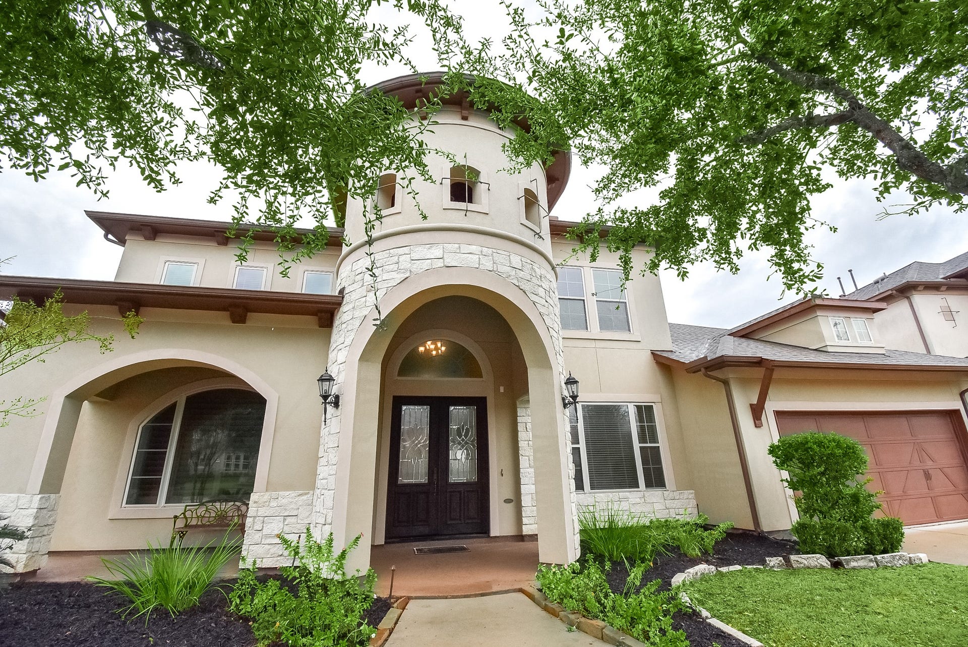7711 Reseda Street, Sugar Land, TX 77479 The unique turret-style enclave creates a distinguished architectural focal point, leading into a wide, sheltered front porch.