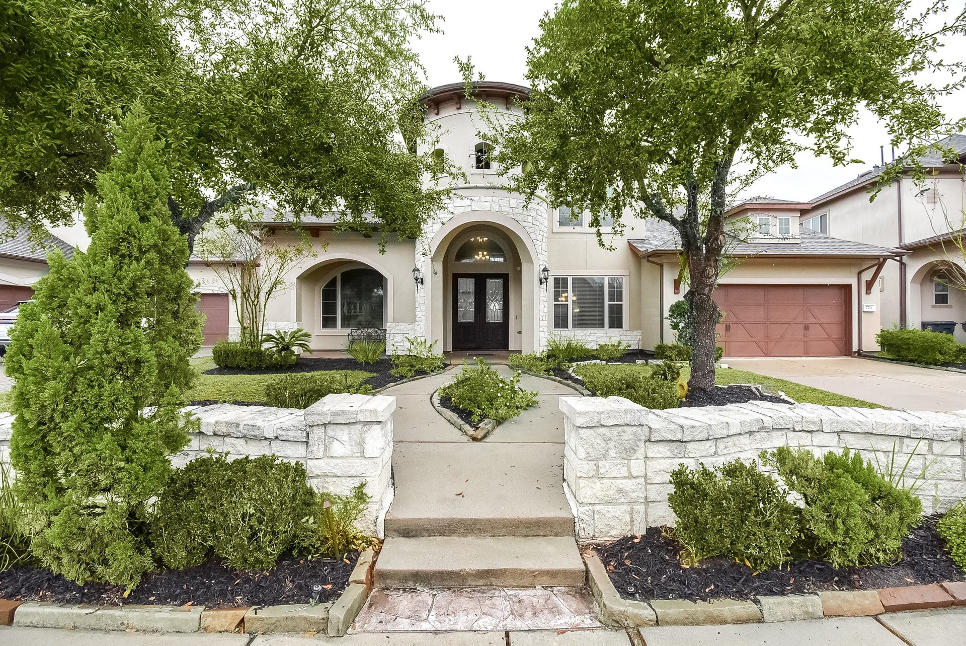 7711 Reseda Street, Sugar Land, TX 77479 A manicured lawn and lovely walkway adorn this David Weekly design, showcasing its expansive footprint and established landscape.