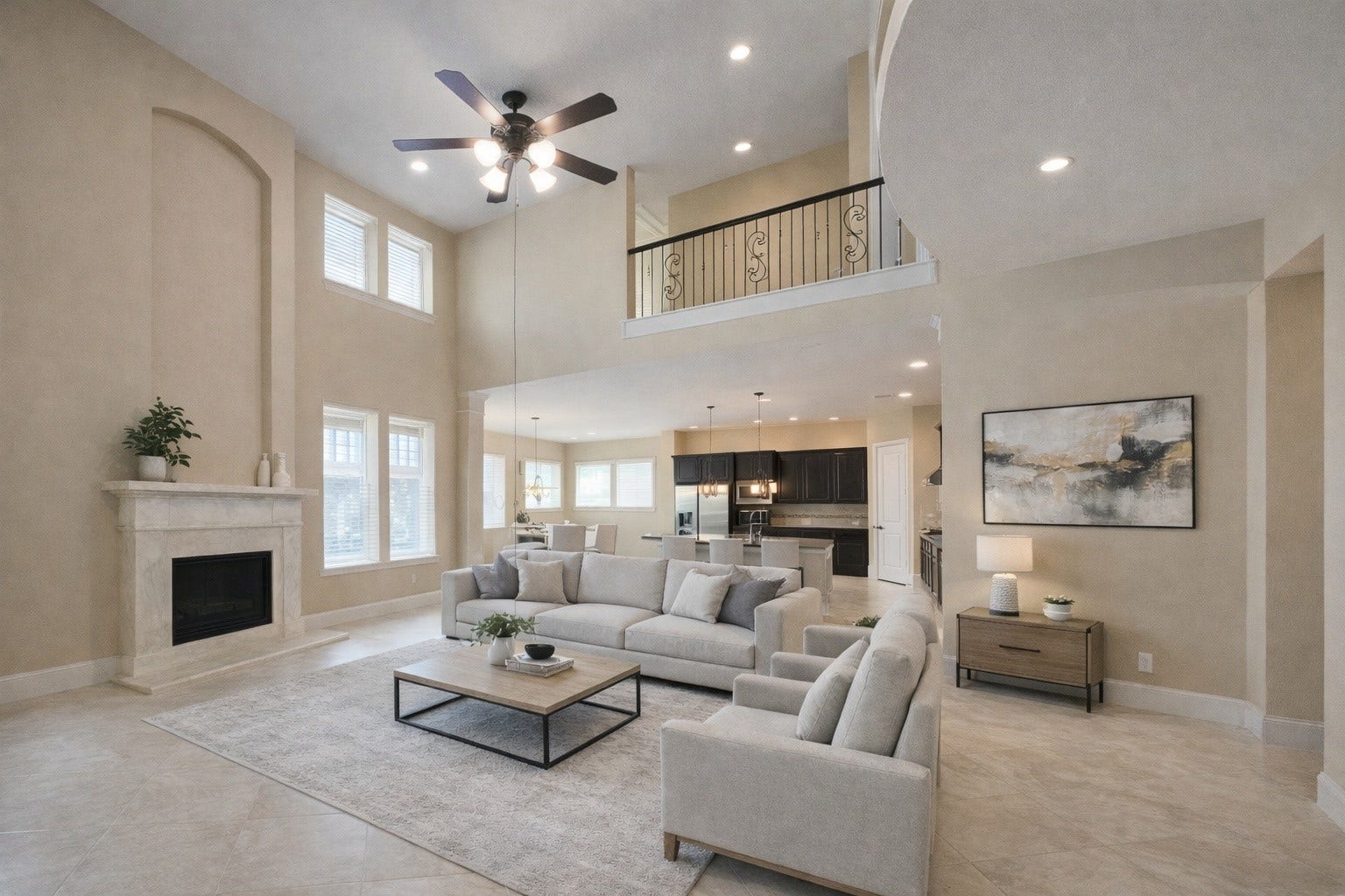 7711 Reseda Street, Sugar Land, TX 77479 Soaring ceilings and a classic fireplace anchor this light-filled lounge, which remains connected to the upper level through an open balcony overlook.