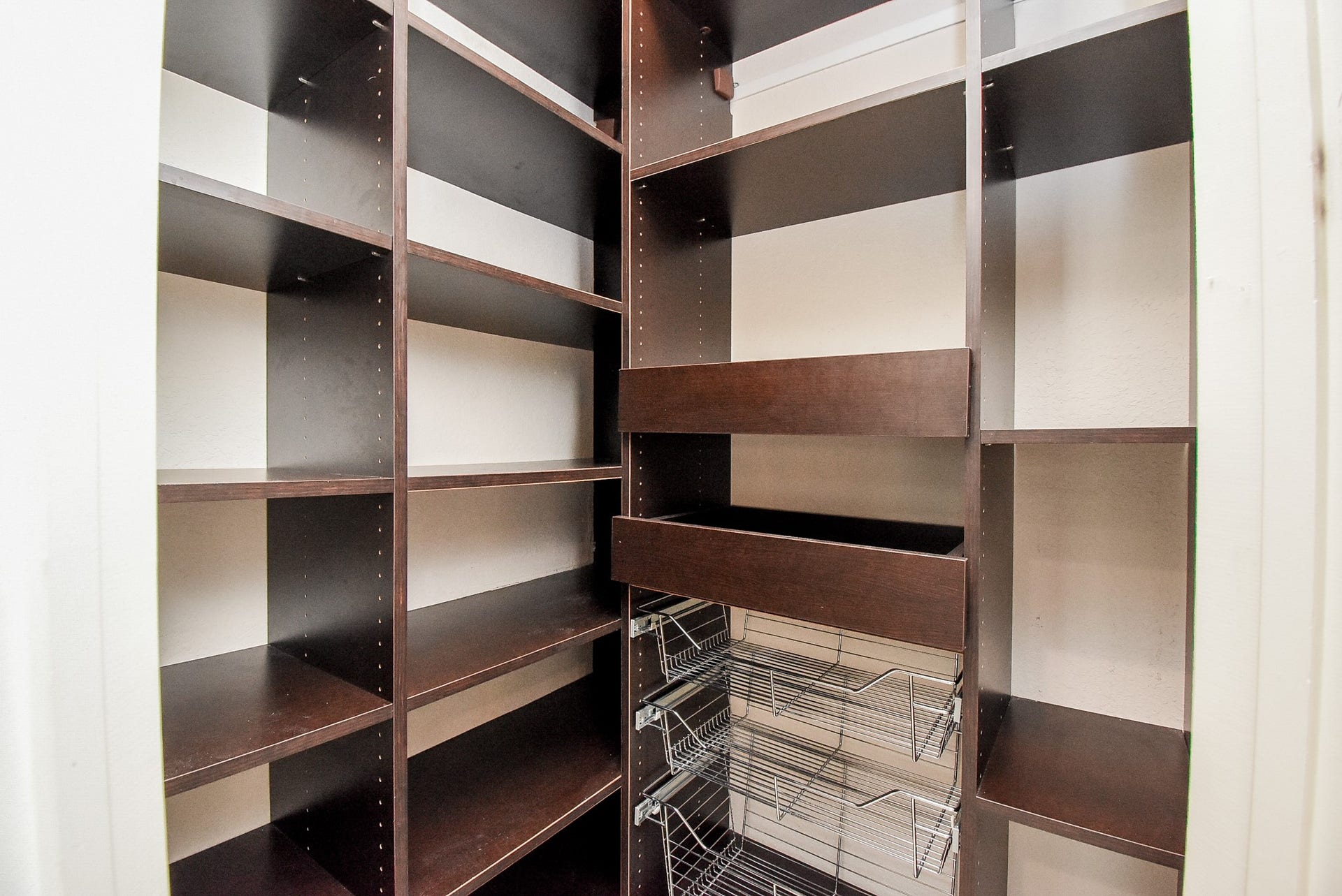 7711 Reseda Street, Sugar Land, TX 77479 Smart organizational solutions and tiered shelving provide a high-capacity storage zone for a perfectly stocked kitchen.