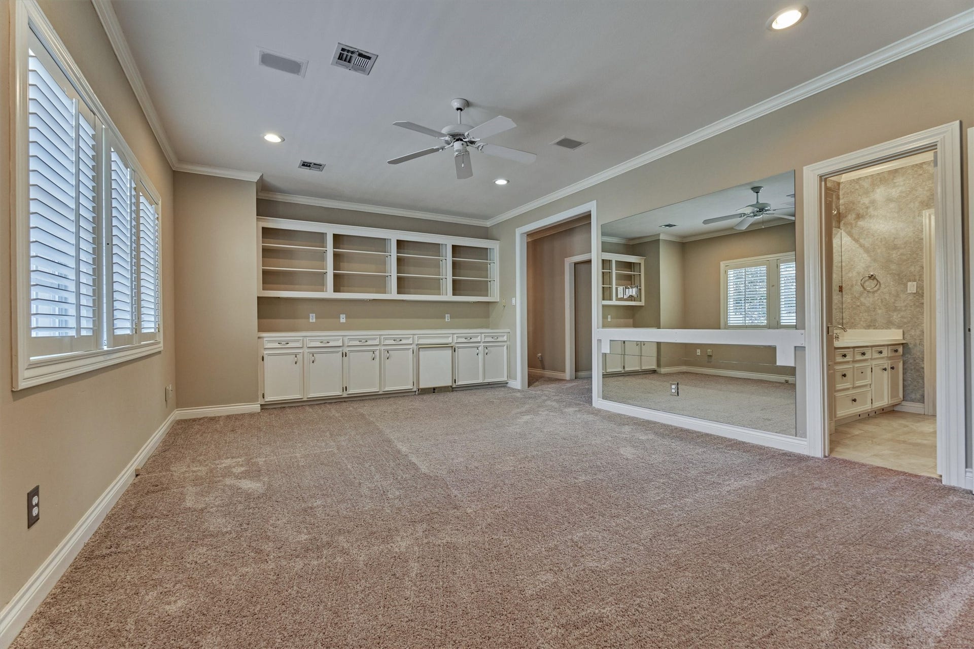 26 S Brokenfern Drive, The Woodlands, TX 77380 Another angle of this big game room shows how much space there is for game nights, movie marathons, or a teen hangout. Built-in shelves and cabinets keep everything organized, and the counter is a handy snack and drink station. The Jack and Jill bath is right next door, and a second staircase leads straight down to the family room, so its easy to move between floors.