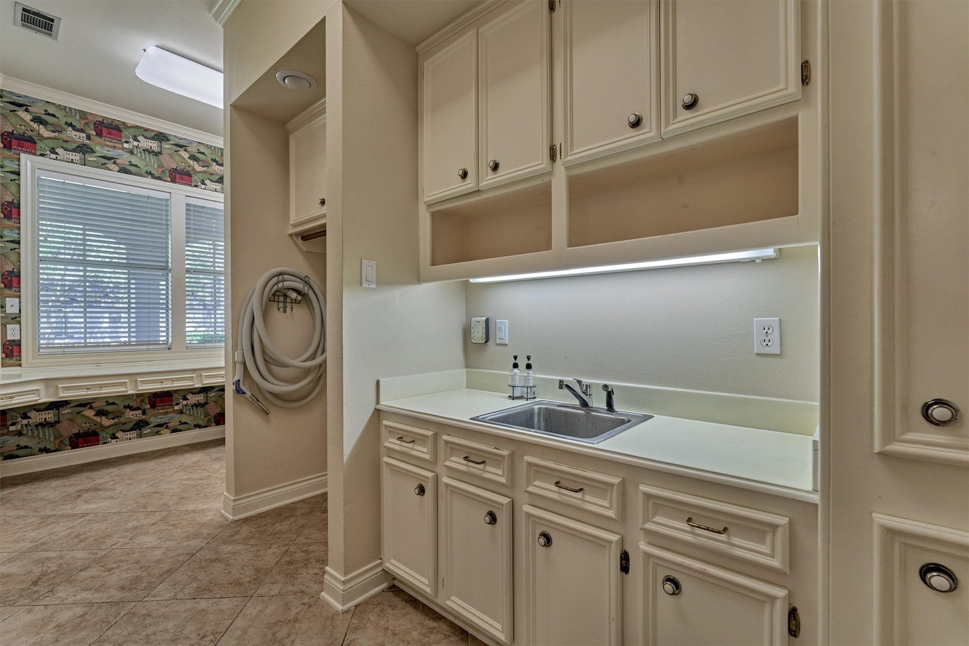 26 S Brokenfern Drive, The Woodlands, TX 77380 Laundry day gets easier in this huge utility room. Tons of cabinet storage, a utility sink, and plenty of counter space keep everything organized, while the desk area makes it a handy spot for crafts, bills, or homework. Washer and dryer hookups are ready to go, and theres room for an extra refrigerator or freezer. Natural light from the window and tile floors make it bright and easy to maintain.