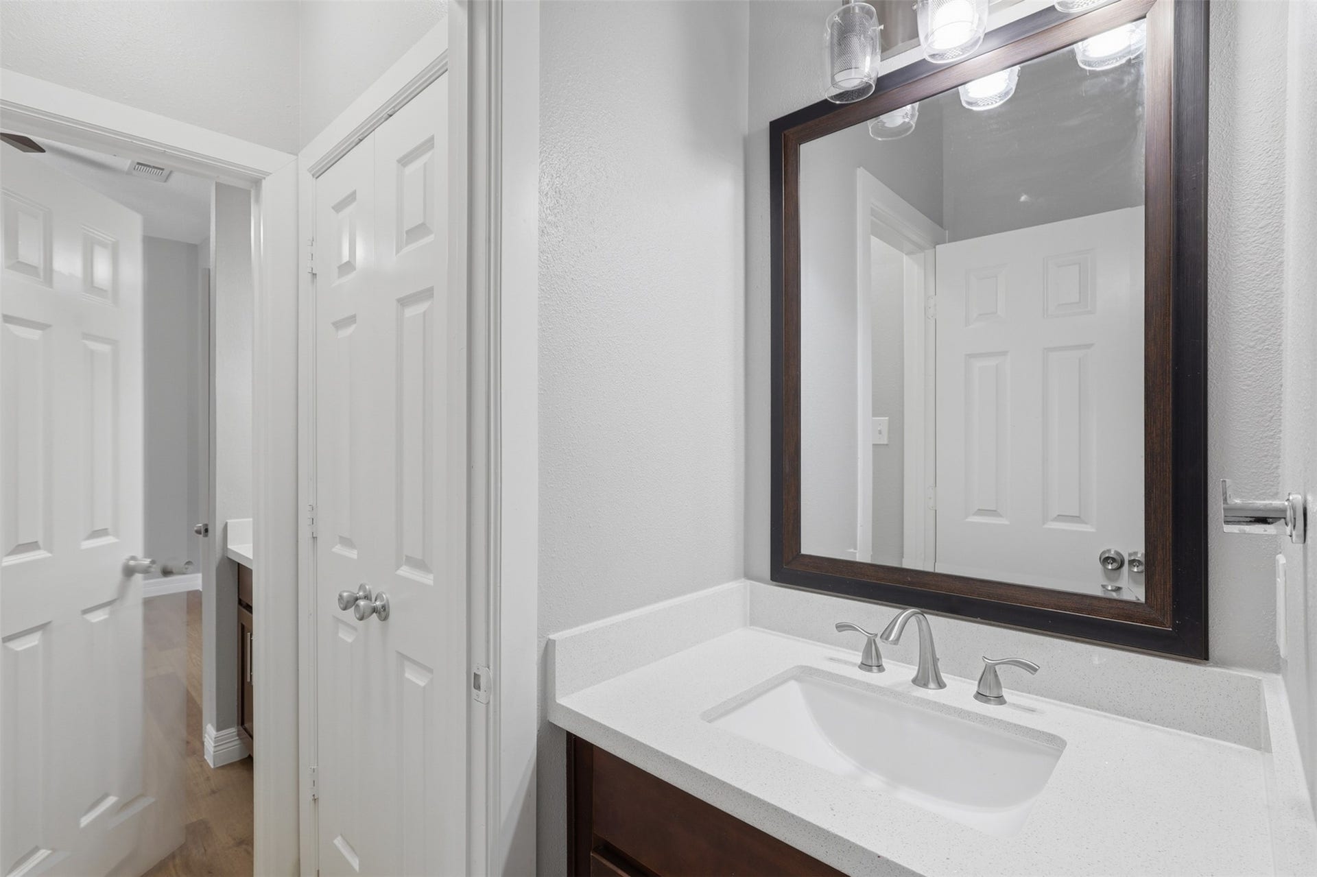 Notice once again how each guest bedroom features its own private vanity, offering added comfort and personal space. Beautiful sparkling quartz countertops, elegant, framed mirrors, designer hardware, and quality finishes create a stylish and functional retreat for family and guests alike. This thoughtfully designed home is ready for you to begin making lasting memories. Make that call today to schedule your private tour!