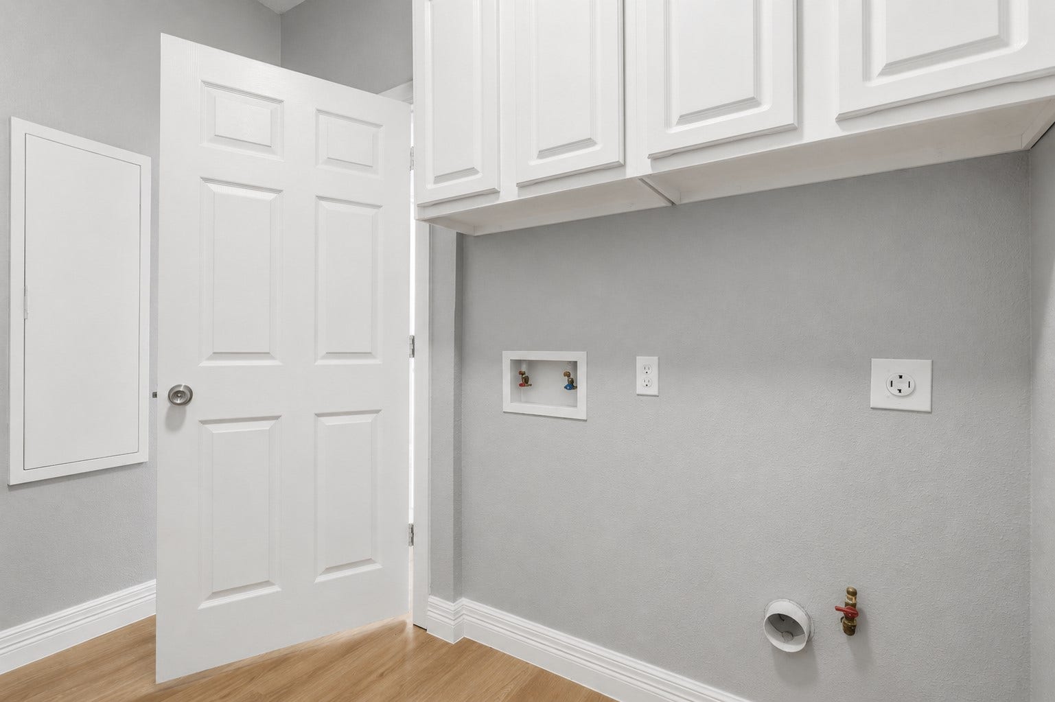 The spacious laundry room offers abundant storage with upgraded cabinetry, making it both functional and organized. Designed for convenience, it includes connections for either a gas or electric dryer, giving you the flexibility to choose what works best for your lifestyle.