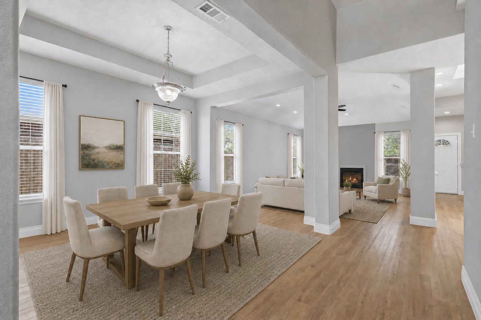 Notice the gorgeous large-plank luxury vinyl flooring that flows throughout the home, adding timeless style and easy maintenance. The elegant formal dining room features dramatic coffered ceilings, a beautiful, updated designer light fixture, and an open layout that connects seamlessly to the gourmet kitchen and spacious family roomperfect for entertaining and everyday living. Photo is Virtually Staged.