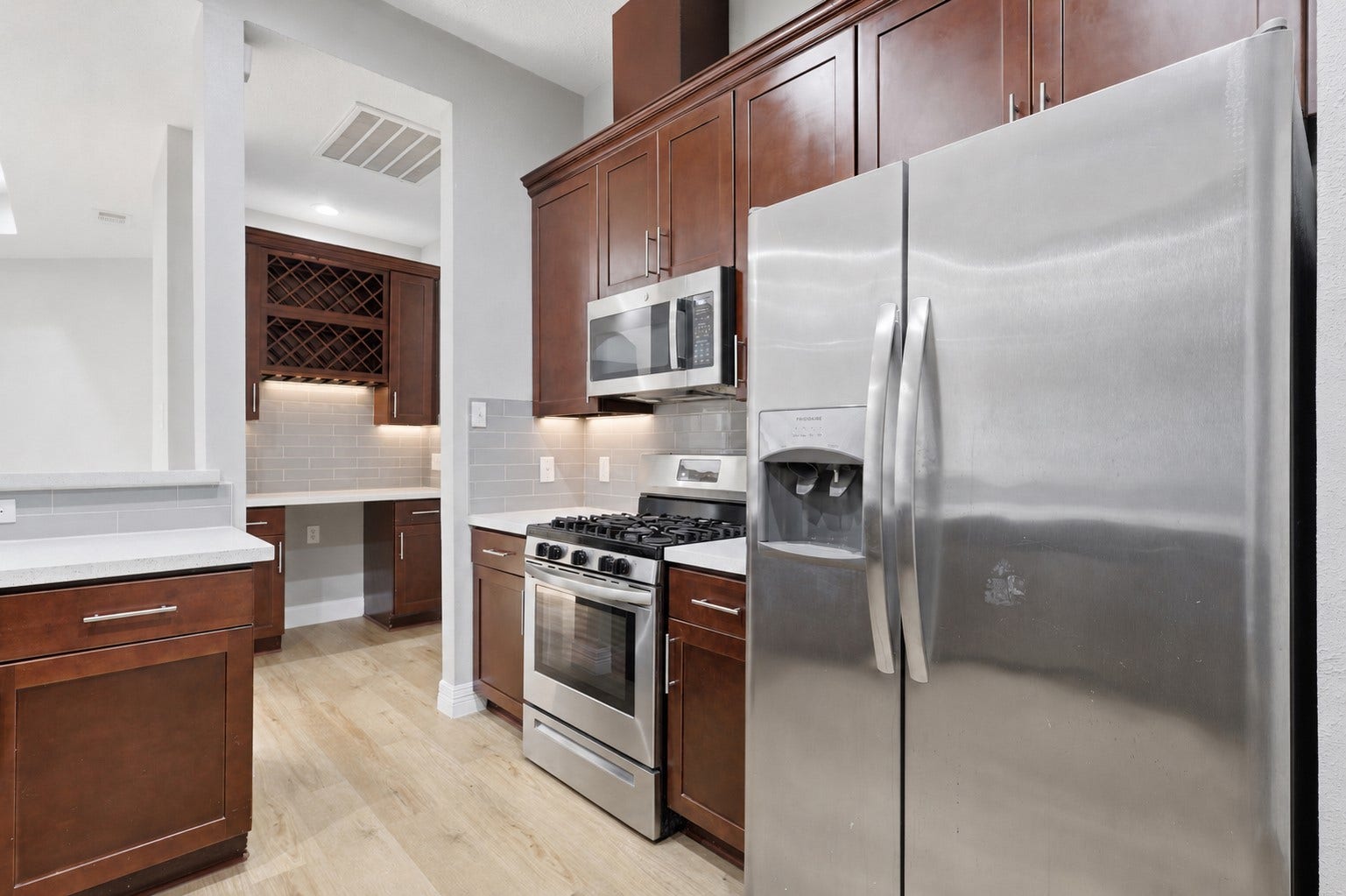 Your gourmet kitchen surrounds you with stunning tall custom cabinetry and gorgeous sparkling quartz countertops that shine like diamonds. The stainless-steel side-by-side refrigerator is included, making this beautiful kitchen move-in ready. With almost everything updated or replaced, this exceptional space offers the perfect blend of style, functionality, and modern convenienceall waiting for you!