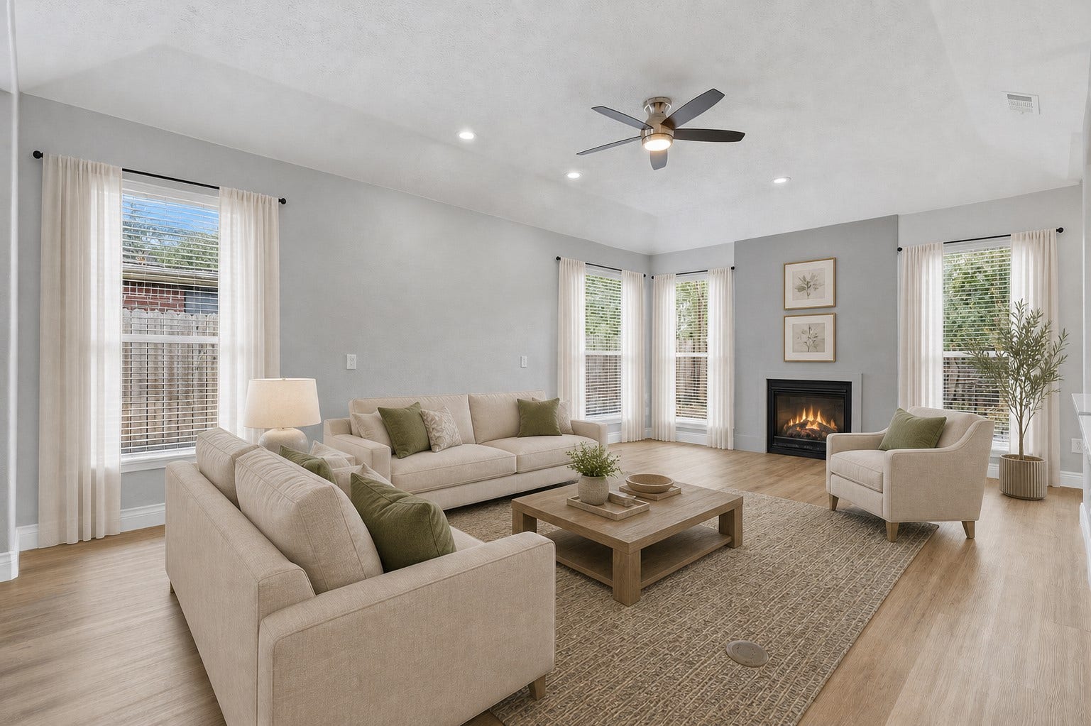 Enjoy the amazing open floor plan highlighted by a spacious family room featuring soaring tray ceilings, a dramatic fireplace, a custom remote-controlled ceiling fan, and beautiful views of your private backyard courtyard. Impressive ceiling heights and abundant natural light create an open, airy atmosphere throughout this stunning one-story ranch home, making it perfect for both relaxing and entertaining. Photo is Virtually Staged.