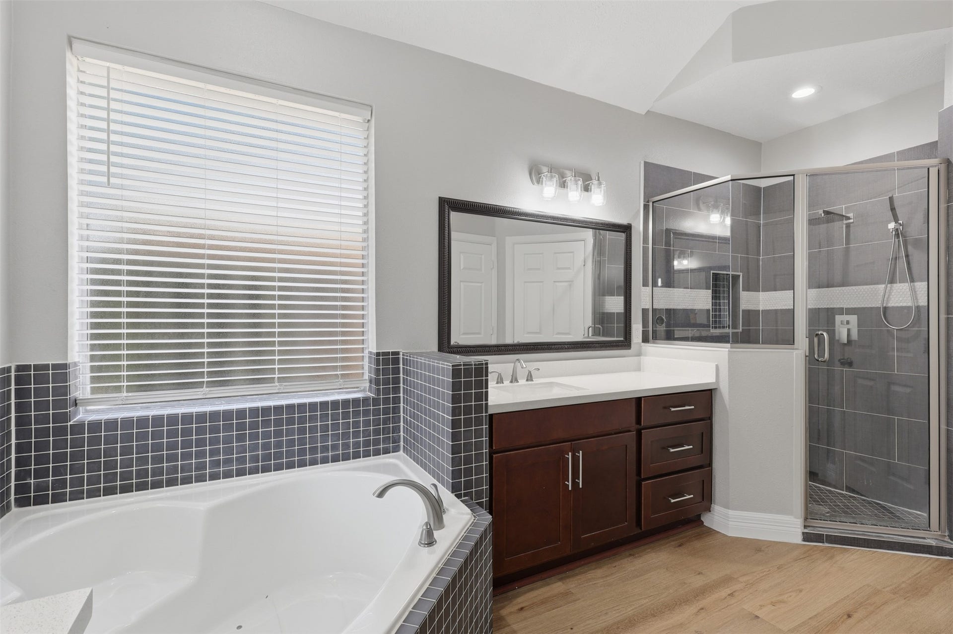Welcome to your luxurious primary suite retreat bathroom, where almost everything has been beautifully updated or replaced! Elegant French doors open to your own private spa-inspired escape, designed for comfort and relaxation. Enjoy the convenience of dual private vanities, each offering abundant cabinetry and drawer space, providing exceptional storage while creating the perfect blend of style, function, and everyday luxury. Large custom walk-in shower!