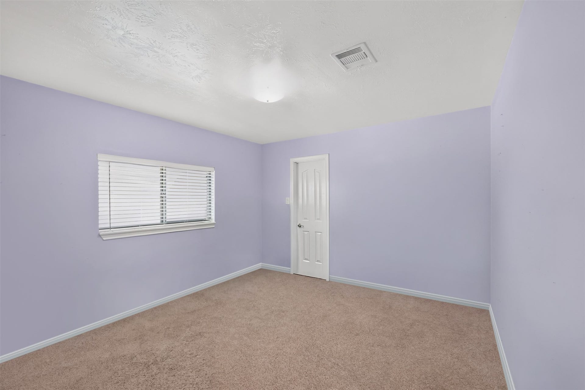 Spacious secondary bedroom with ample natural light and a large closet.