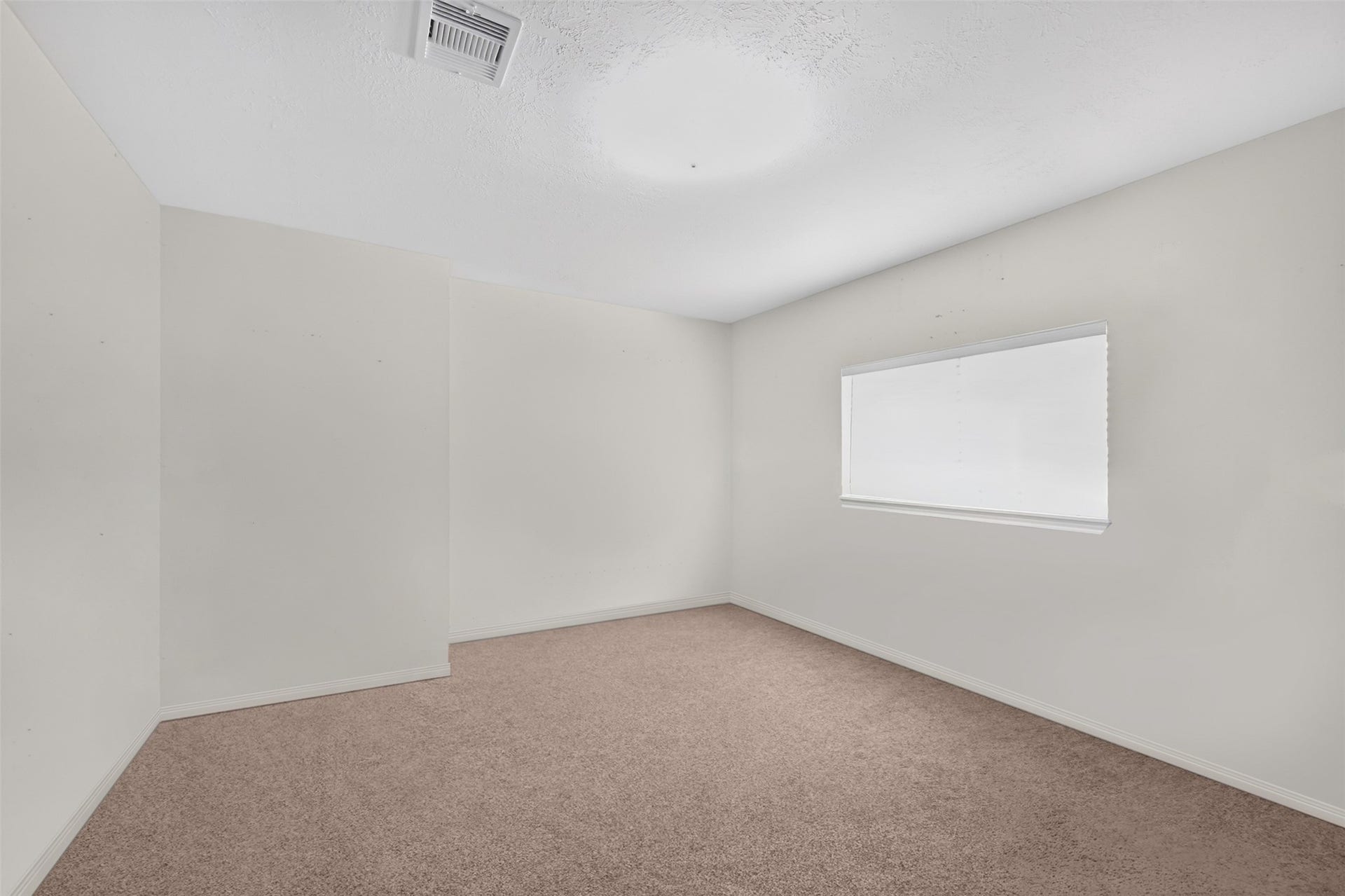 Versatile secondary bedroom ideal for family, guests, or a home office.