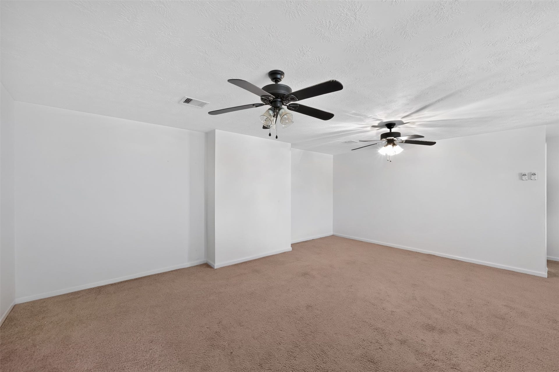 Oversized game room or flex space with ceiling fans and endless possibilities.