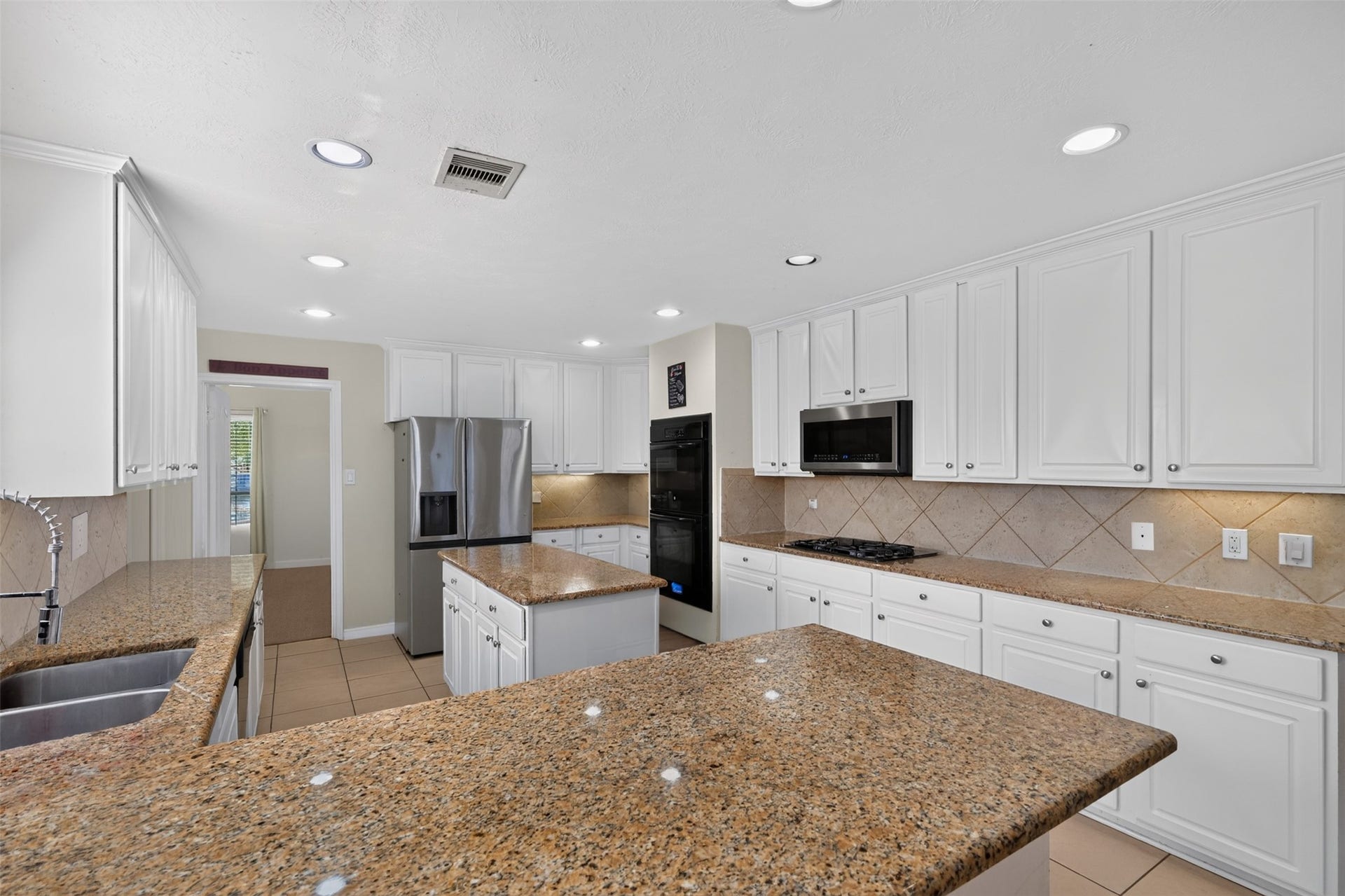 Well-appointed kitchen with granite countertops, generous storage, and a functional layout.