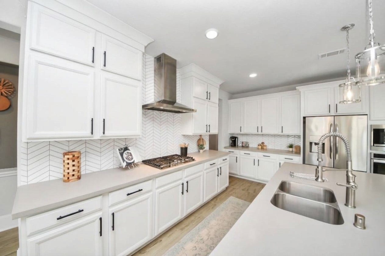 Virtually staged with white cabinets to show what it could look like if cabinets were painted.