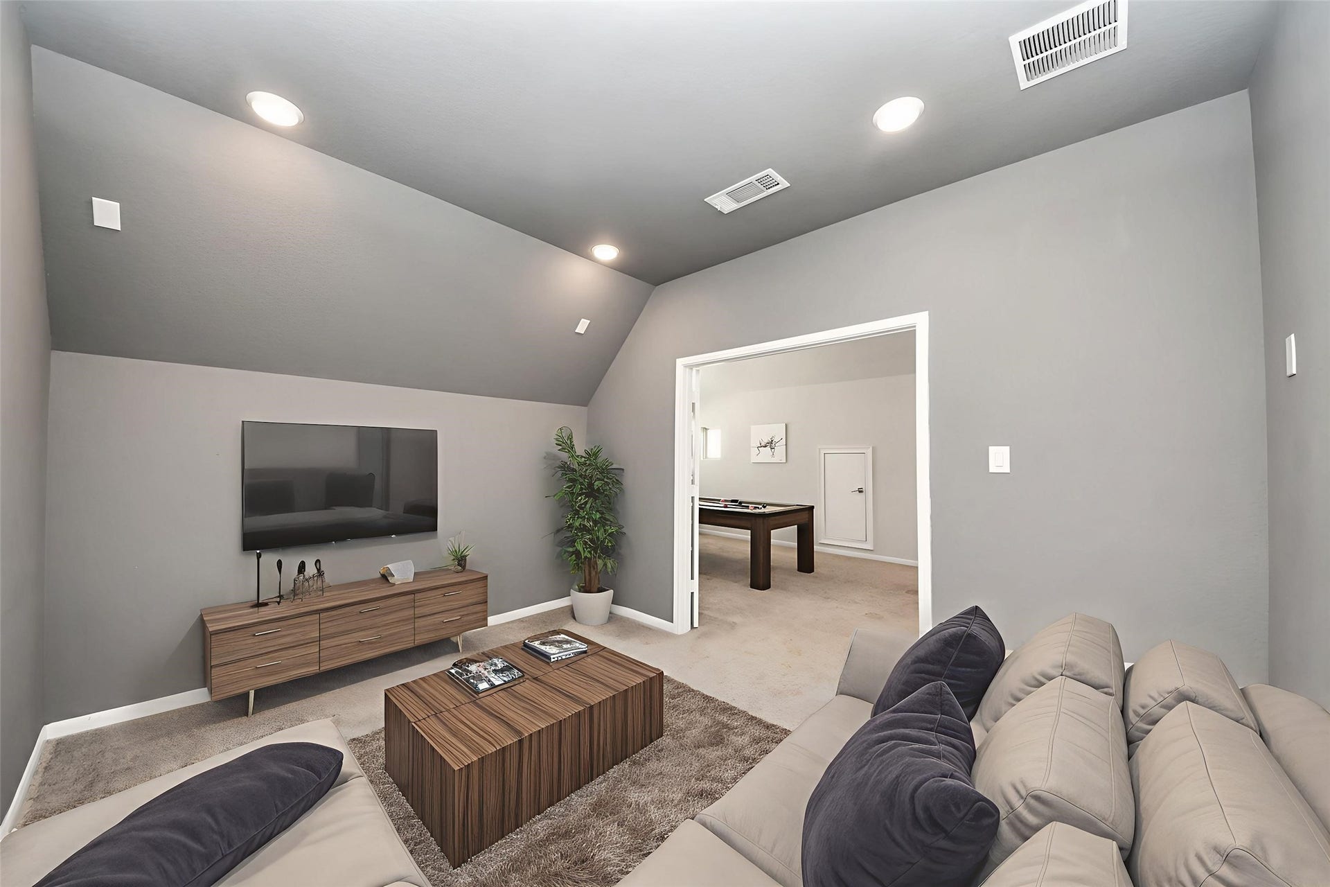 Experience cinematic comfort in this virtually staged media room, perfect for immersive movie nights and relaxation.