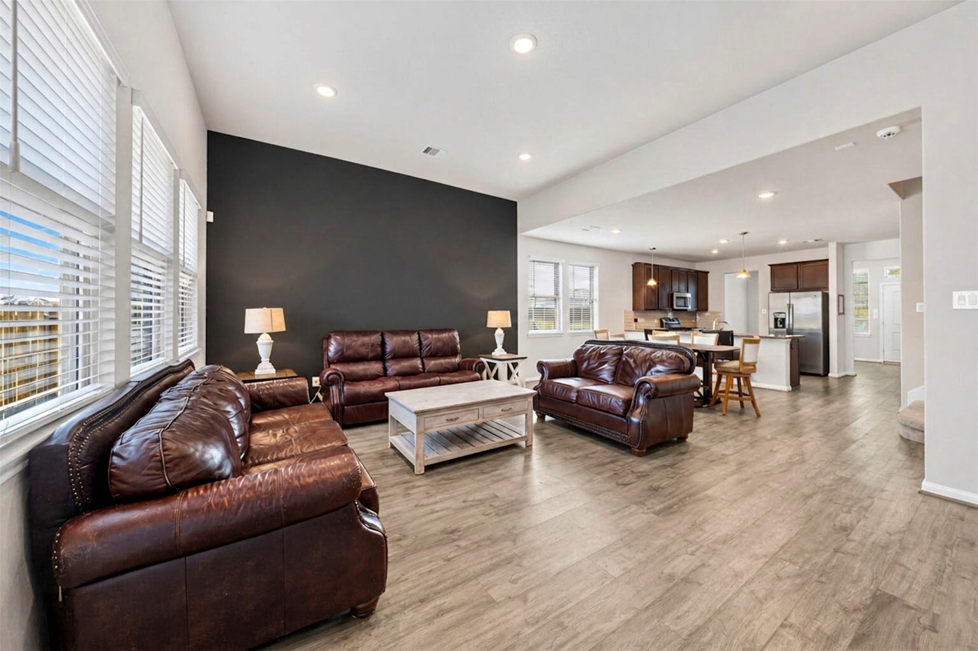 Family room features laminate flooring natural light and great space!