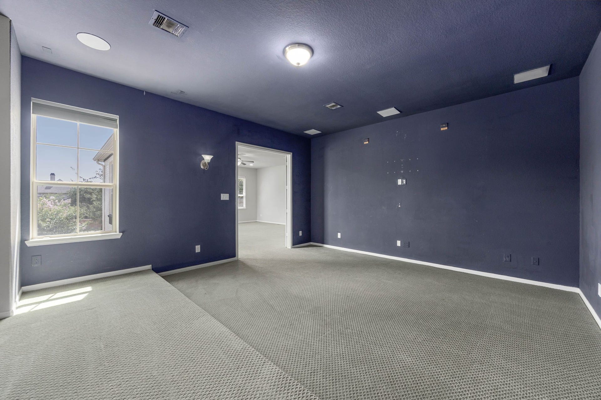 10606 Comeaux Lane, Richmond, TX 77407 A dedicated media room features a raised platform for tiered seating, sconce lighting, and a bold accent wall a ready-made space for movie nights.
