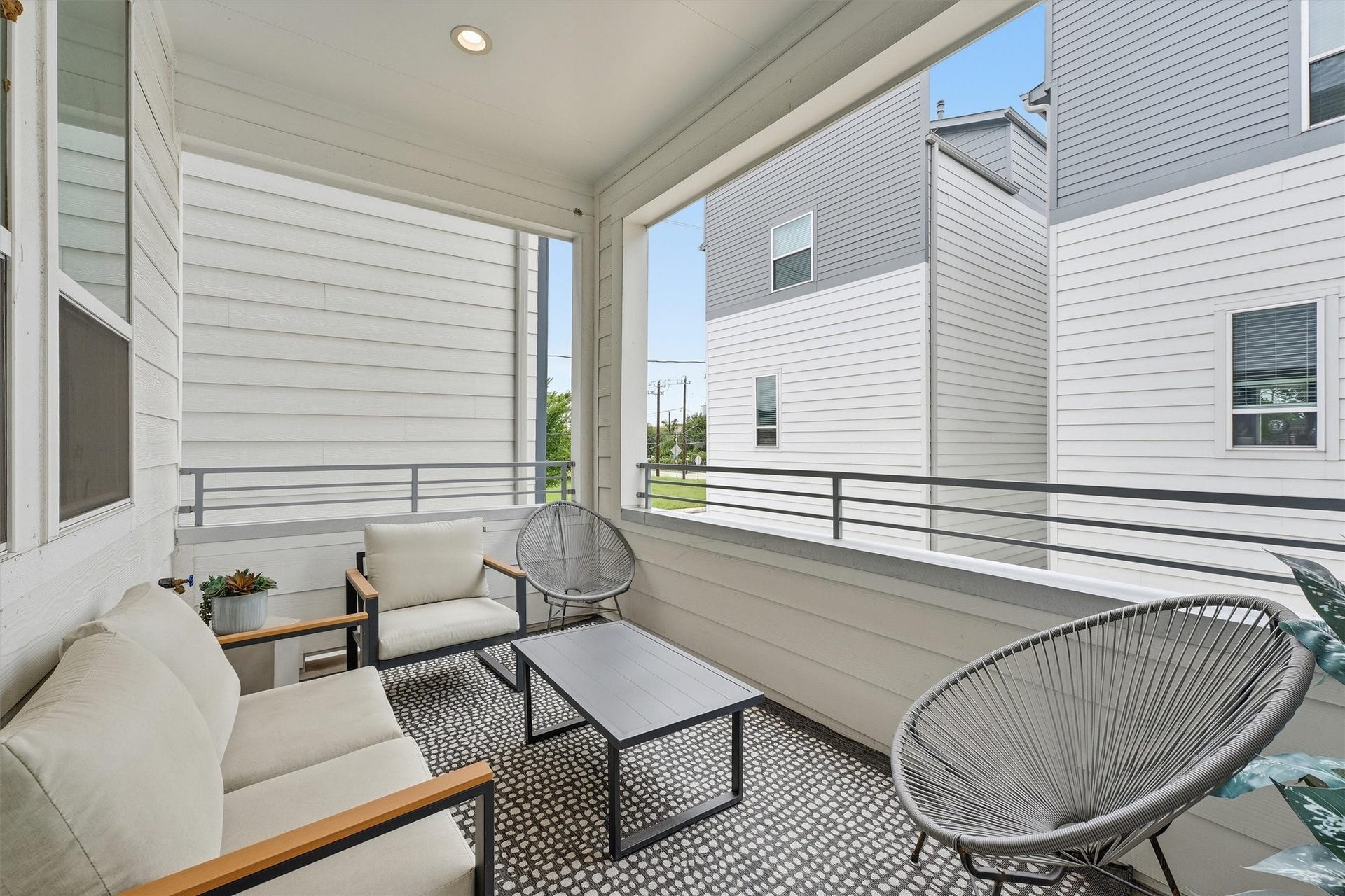 Experience serene outdoor living on this stylish balcony, ideal for relaxation and entertaining in a modern setting.
