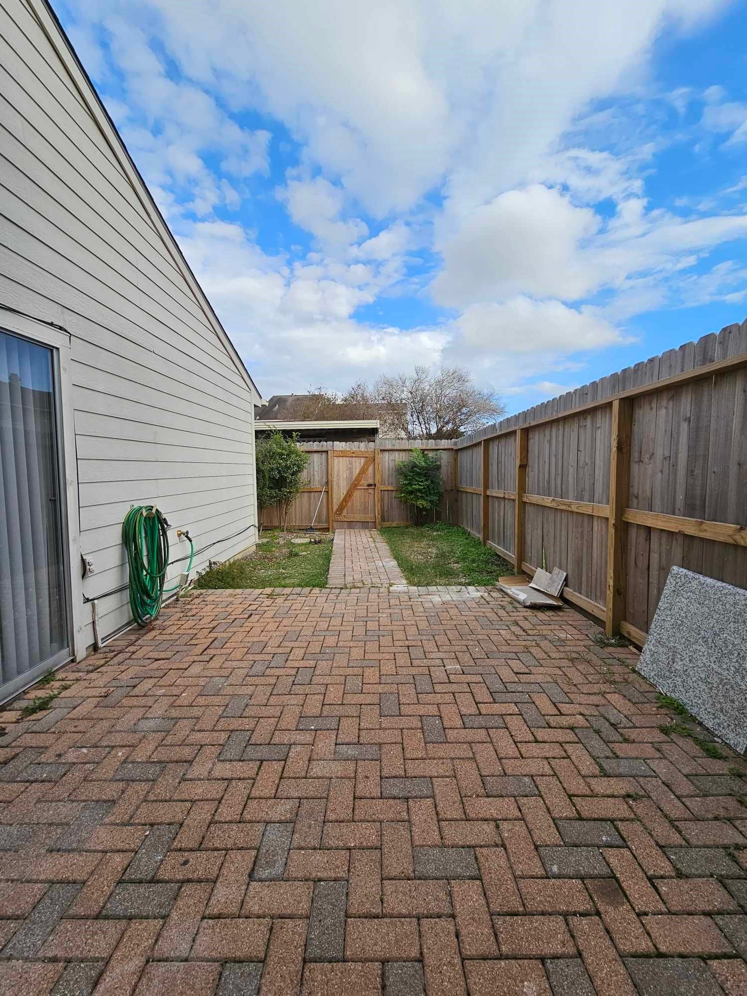 Backyard to carport. View from back door